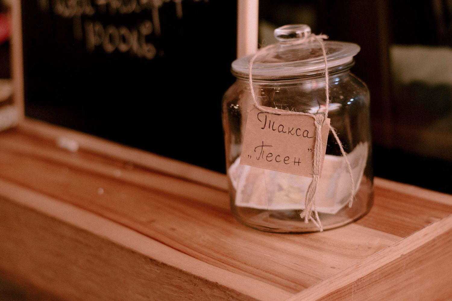 Glass jars and containers arranged on a wooden counter surface.