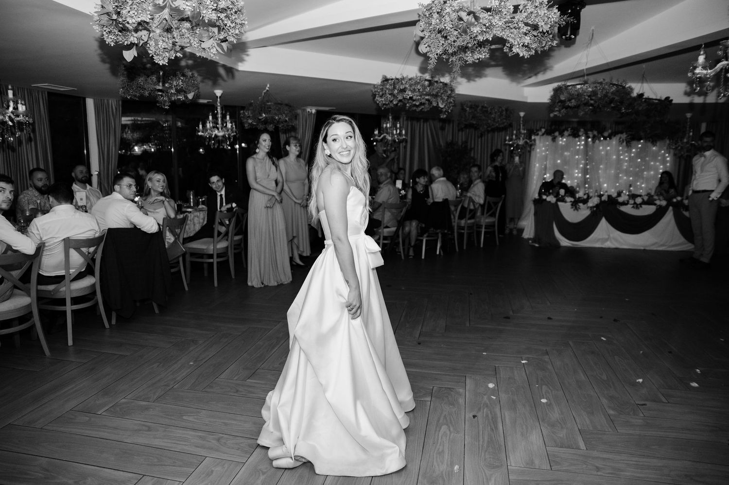 Black and white wedding reception photos show couples dancing and celebrating on the dance floor at an elegant venue.