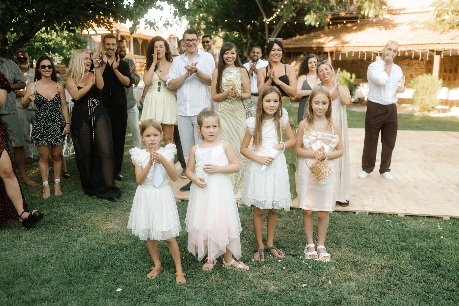 A sequence of wedding party photos showing people in white dresses and formal attire gathered outdoors during sunset.
