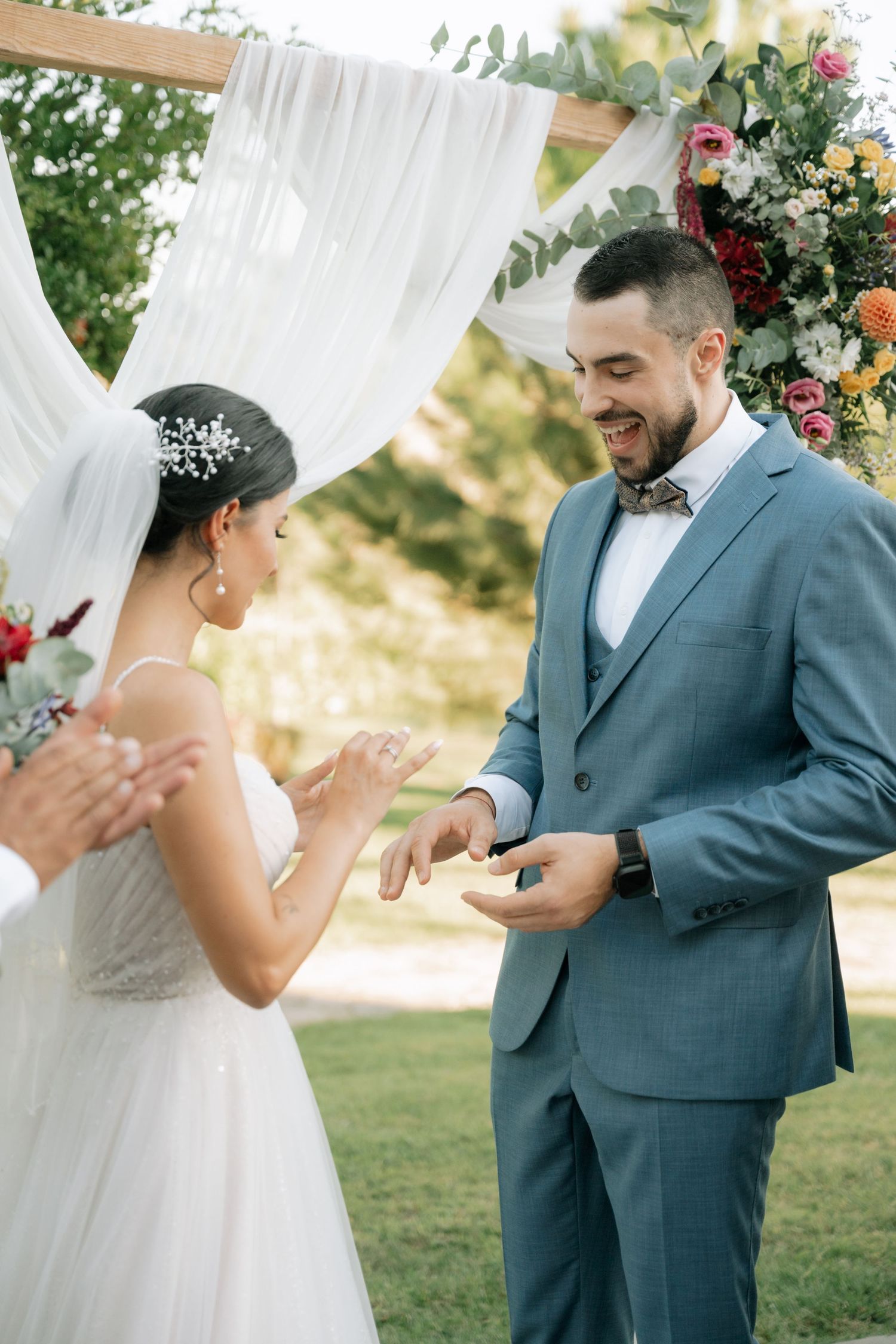 A series of wedding ceremony photos showing emotional first look moments between a couple in a garden setting.