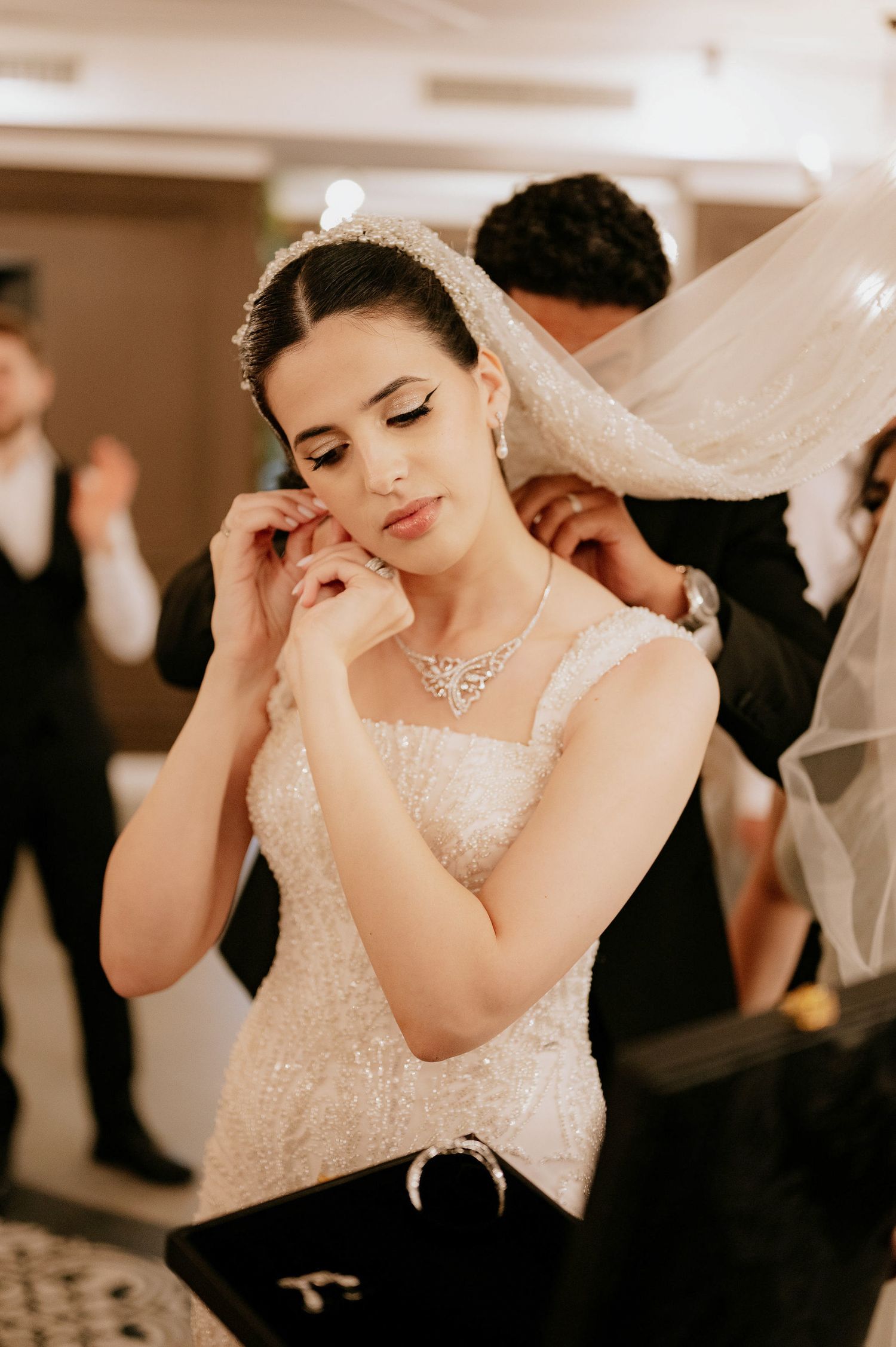 Emotional wedding reception moments captured in warm indoor lighting.