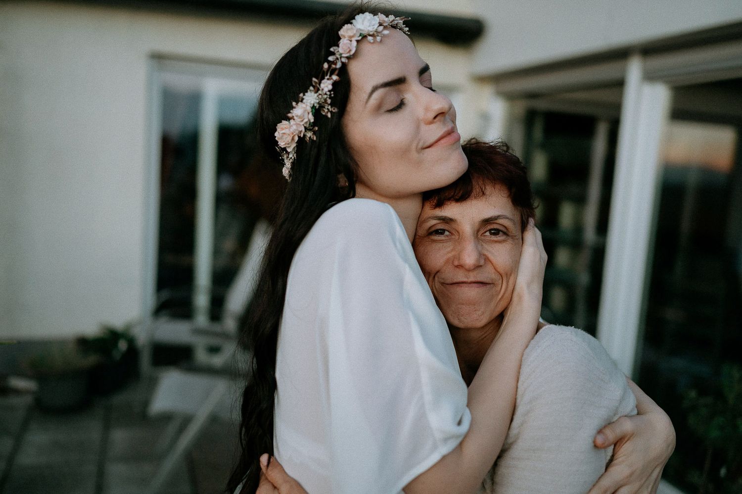 Candid moments of people wearing floral headpieces and white clothing.