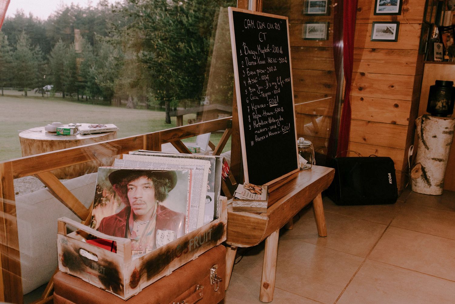 Wooden lodge interior with chalkboard signs and rustic decor.