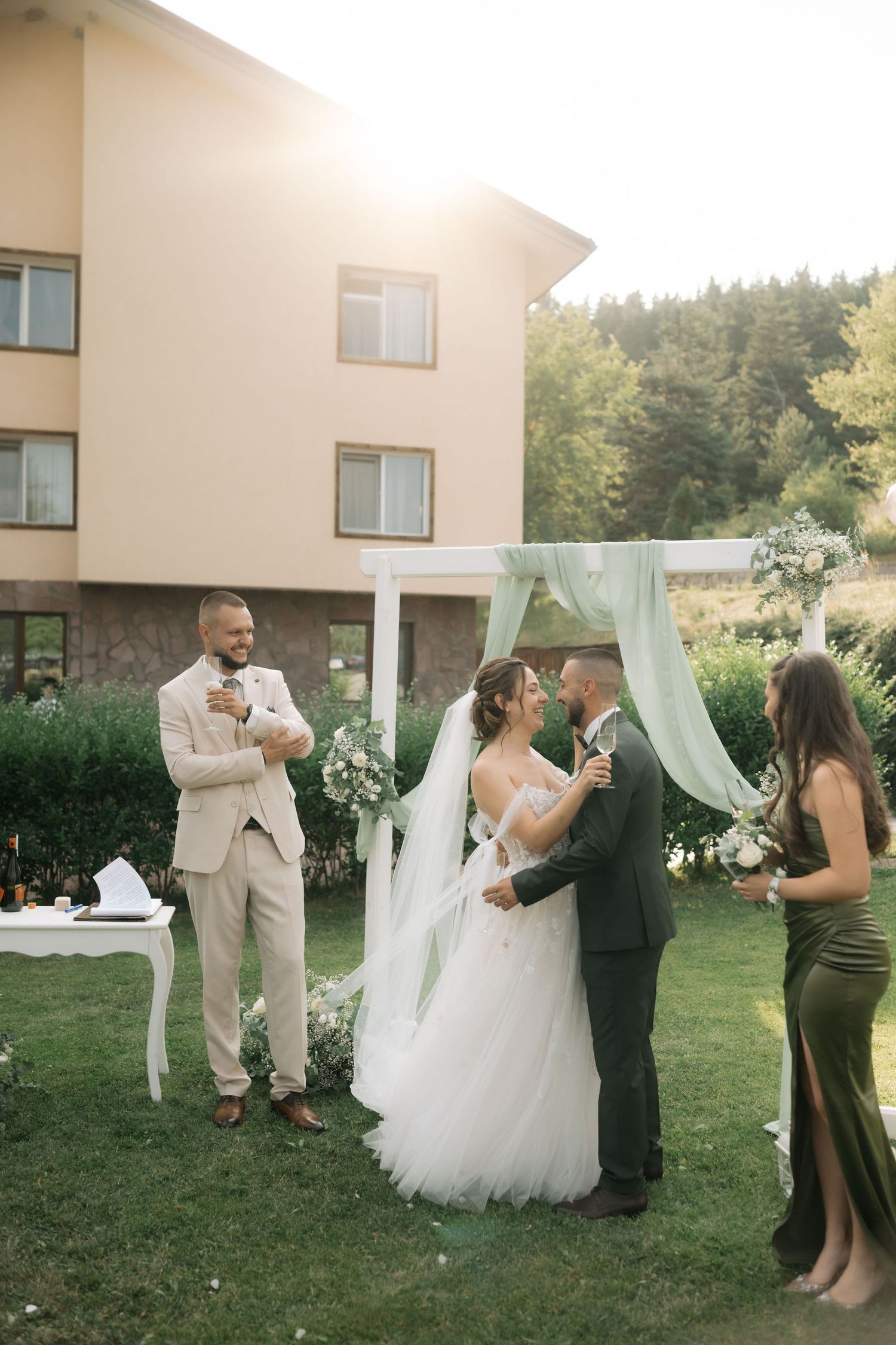 Outdoor wedding ceremony moments captured in a series of candid photos showing celebrations on a grassy lawn at sunset.