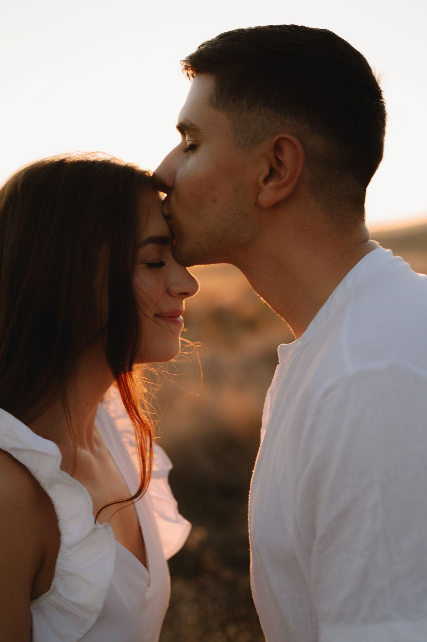 Romantic couple sharing tender moments at sunset in a series of intimate profile portraits.