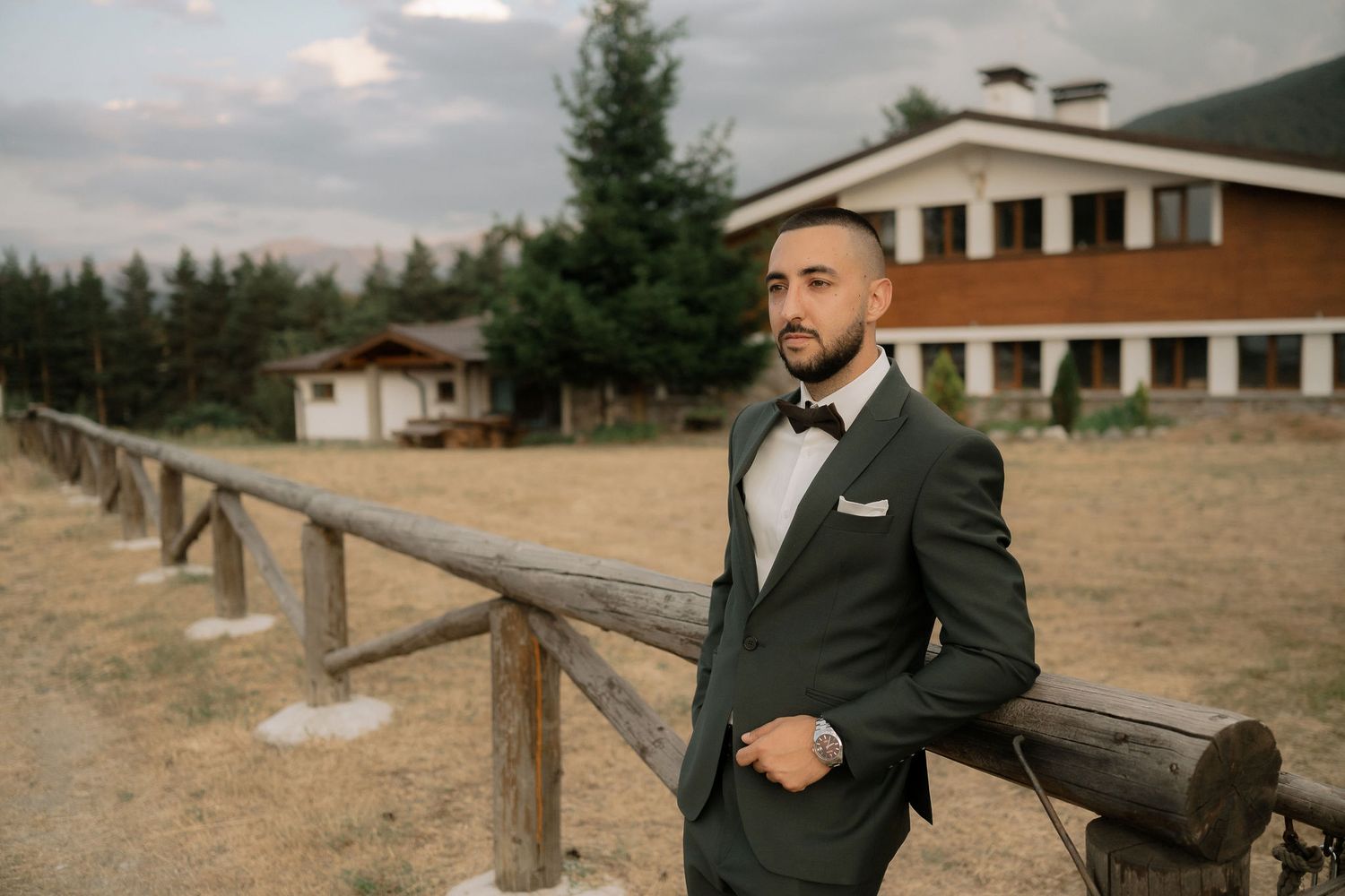 A series of five photos showing a person in formal attire posing near wooden fences and ranch buildings in a rural setting.