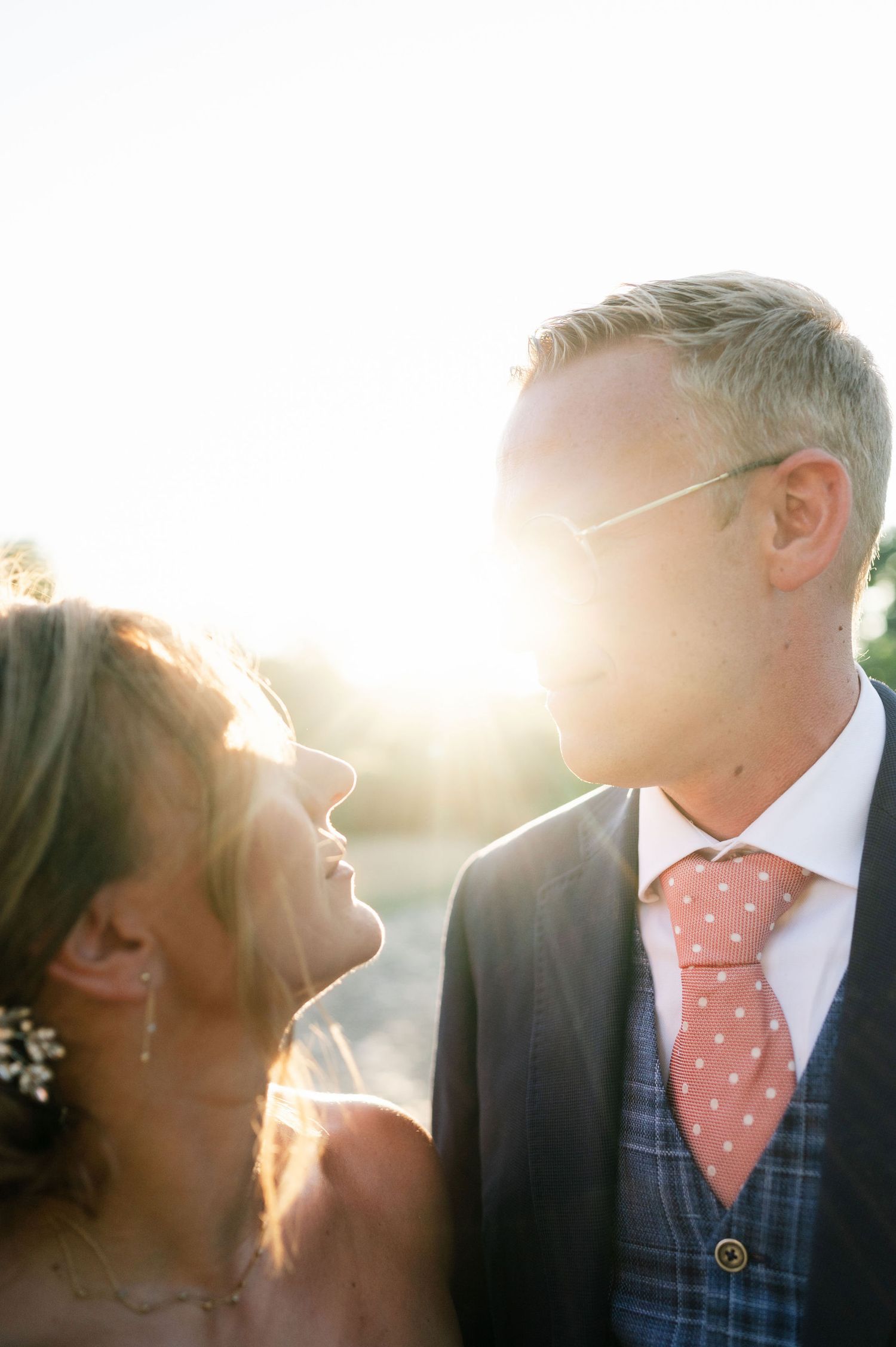 Romantic sunset portraits featuring elegant wedding attire and natural lighting.