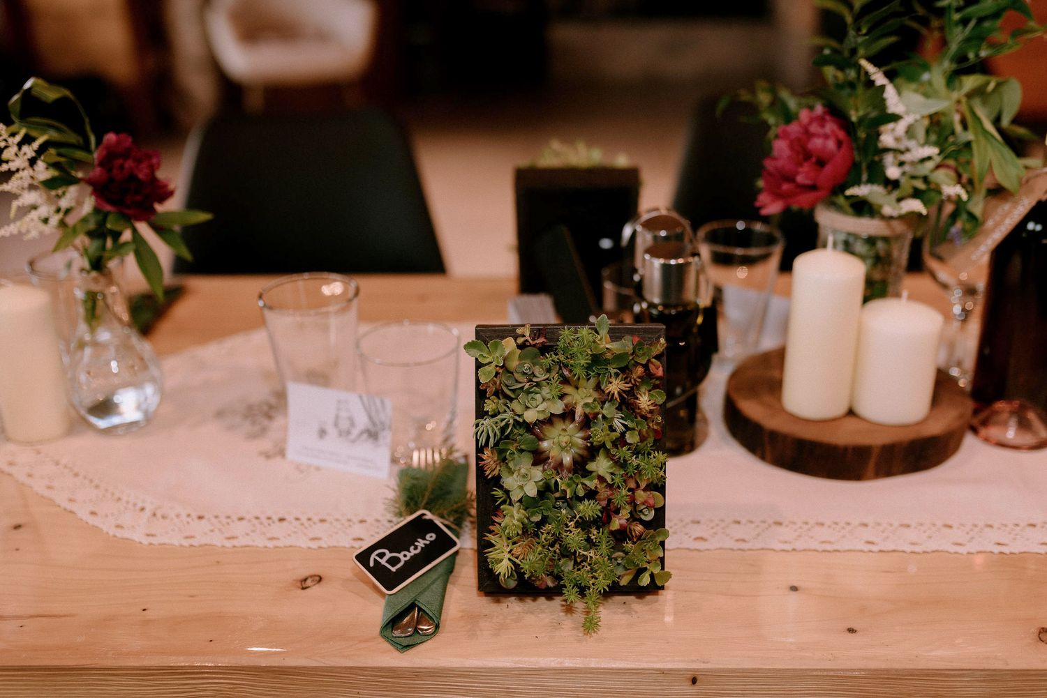 Close-up of wedding table decorations featuring floral arrangements and vintage-style place settings.