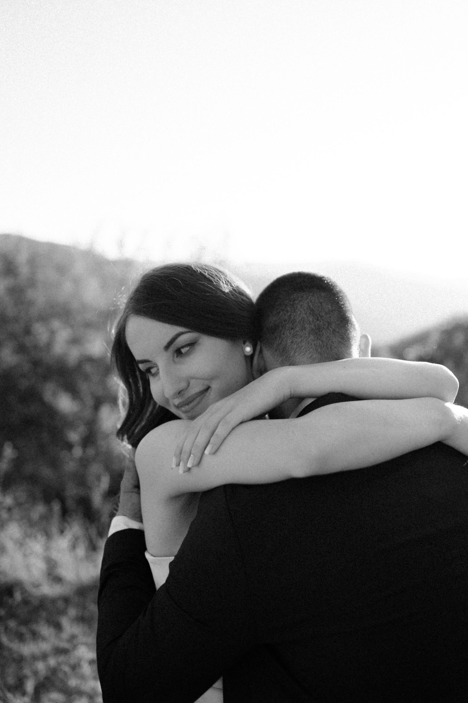 Black and white intimate wedding portrait showing tender embrace.