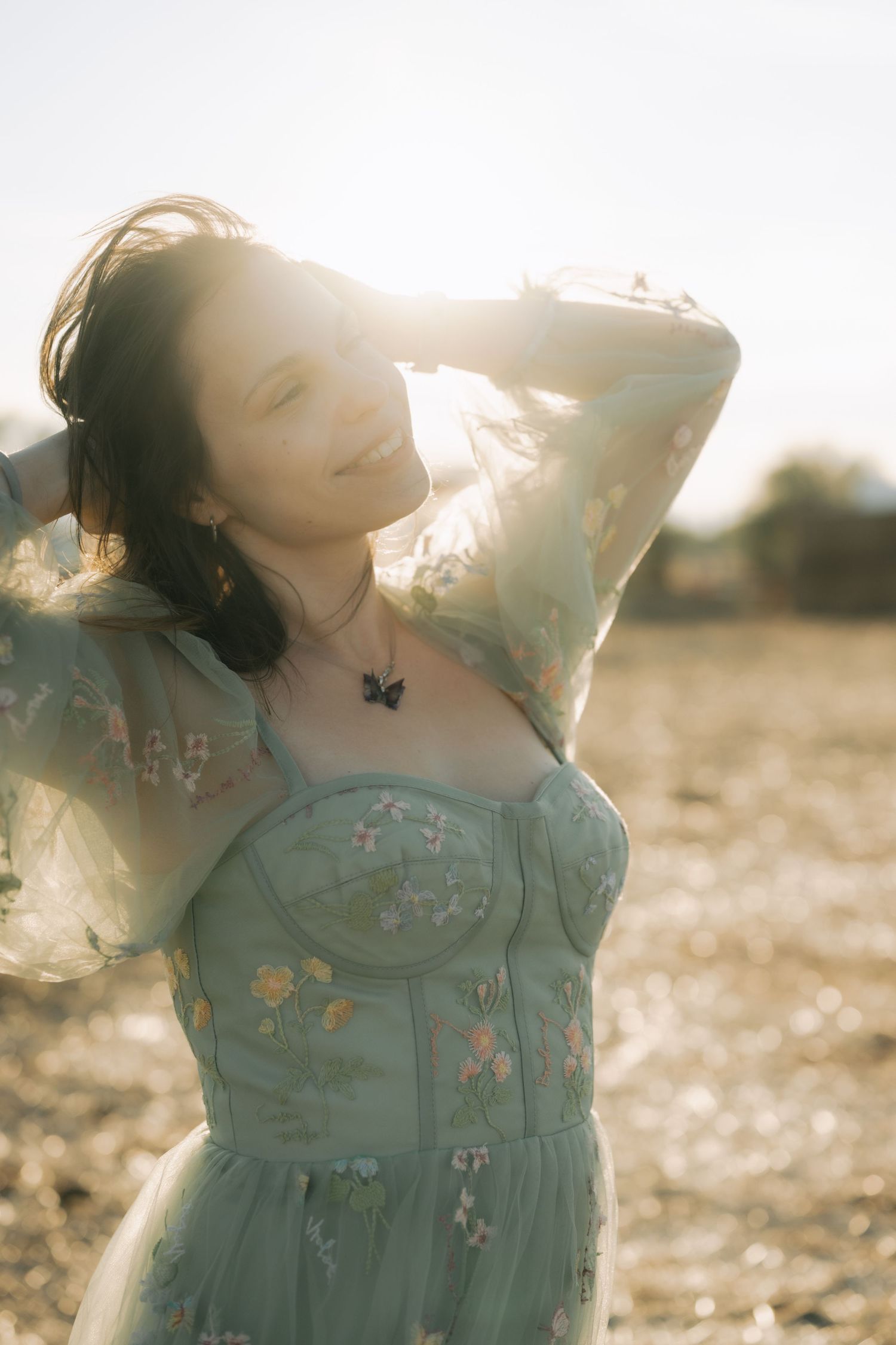 A dreamy triptych shows a person in a mint green dress with butterfly details basking in golden sunlight.