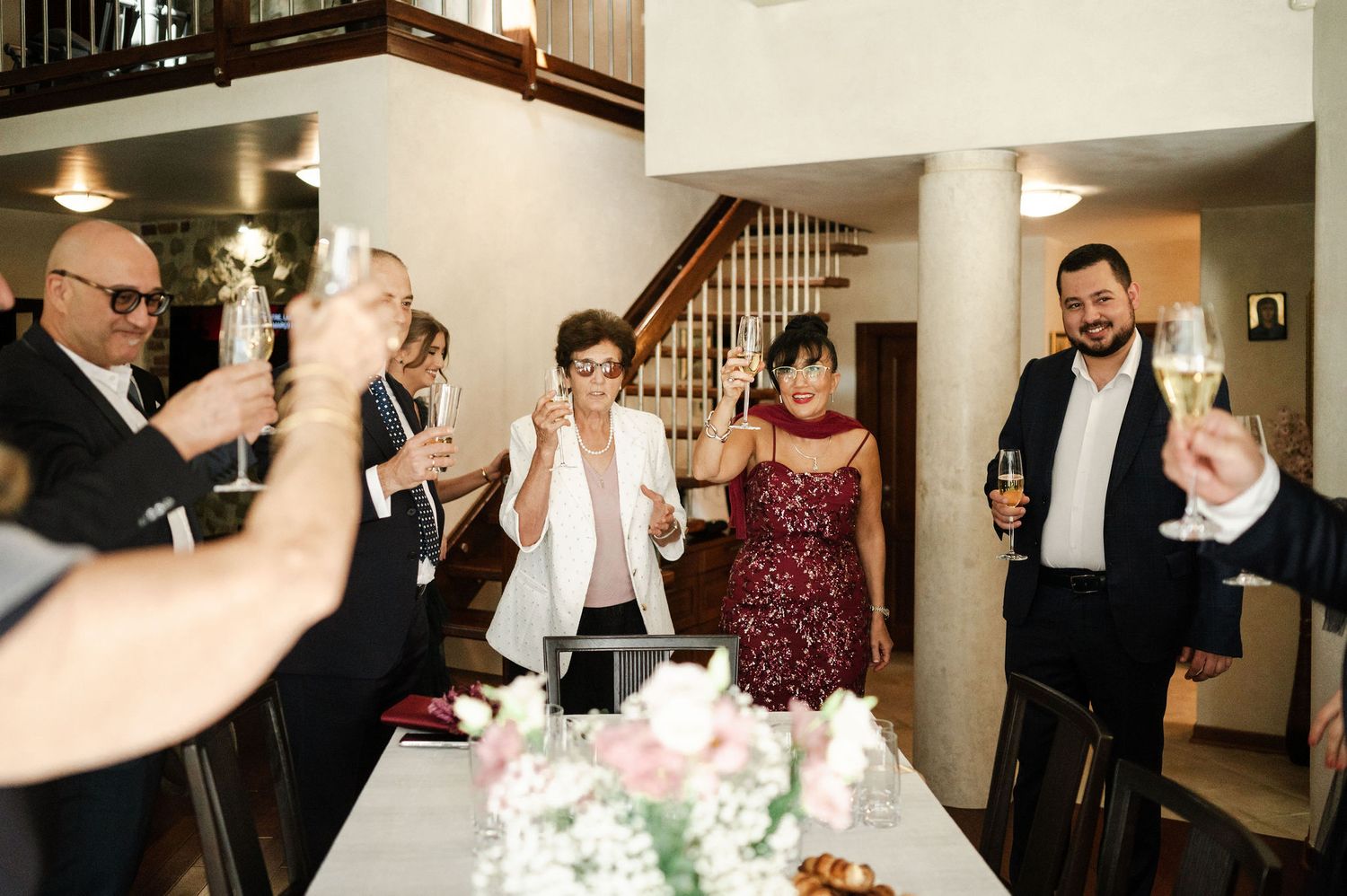 Wedding party celebrating and dancing together in an indoor venue.