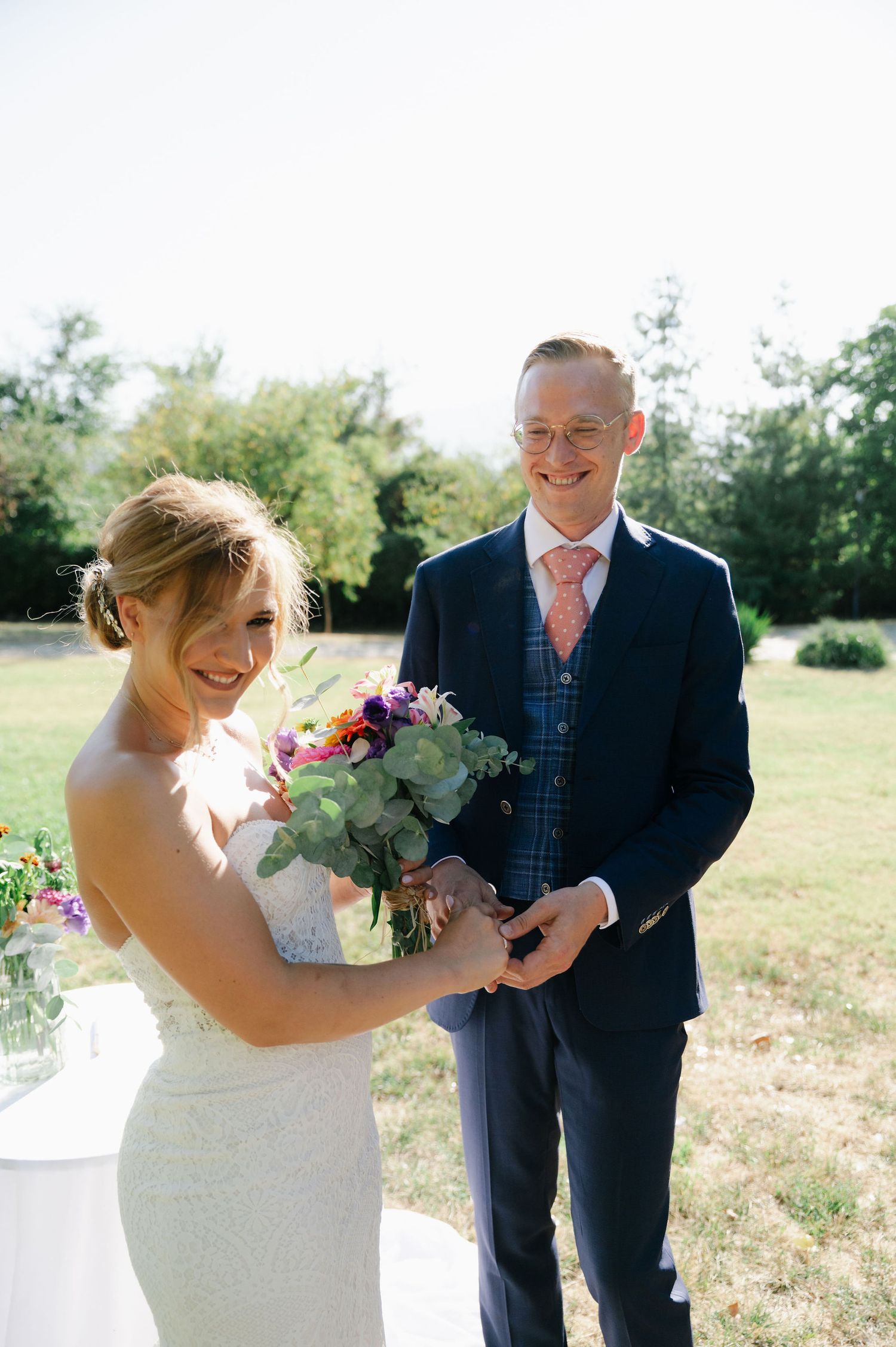 Candid wedding moments with couple sharing laughter while holding floral bouquets.