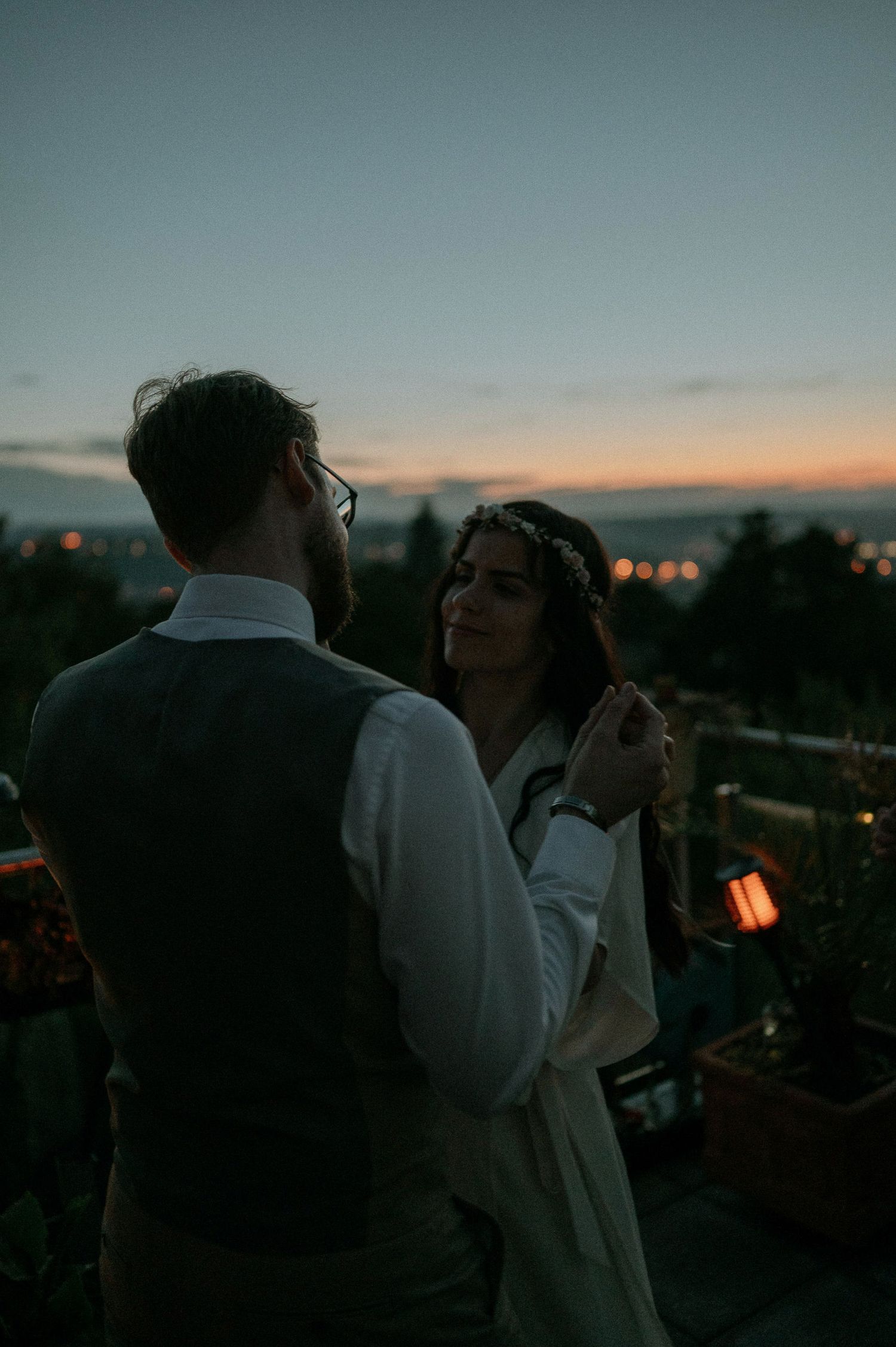 Intimate outdoor evening gathering with soft lighting and sunset sky.