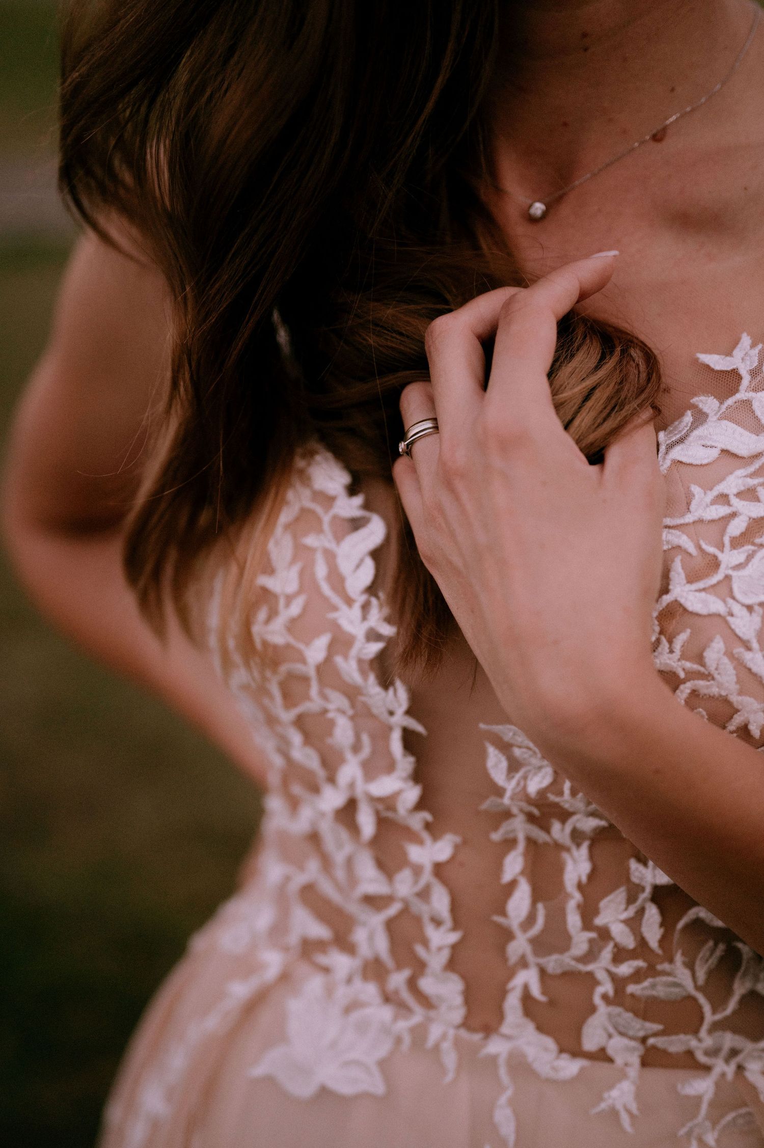 Intimate detail shots of white floral appliques on sheer wedding dress fabric.