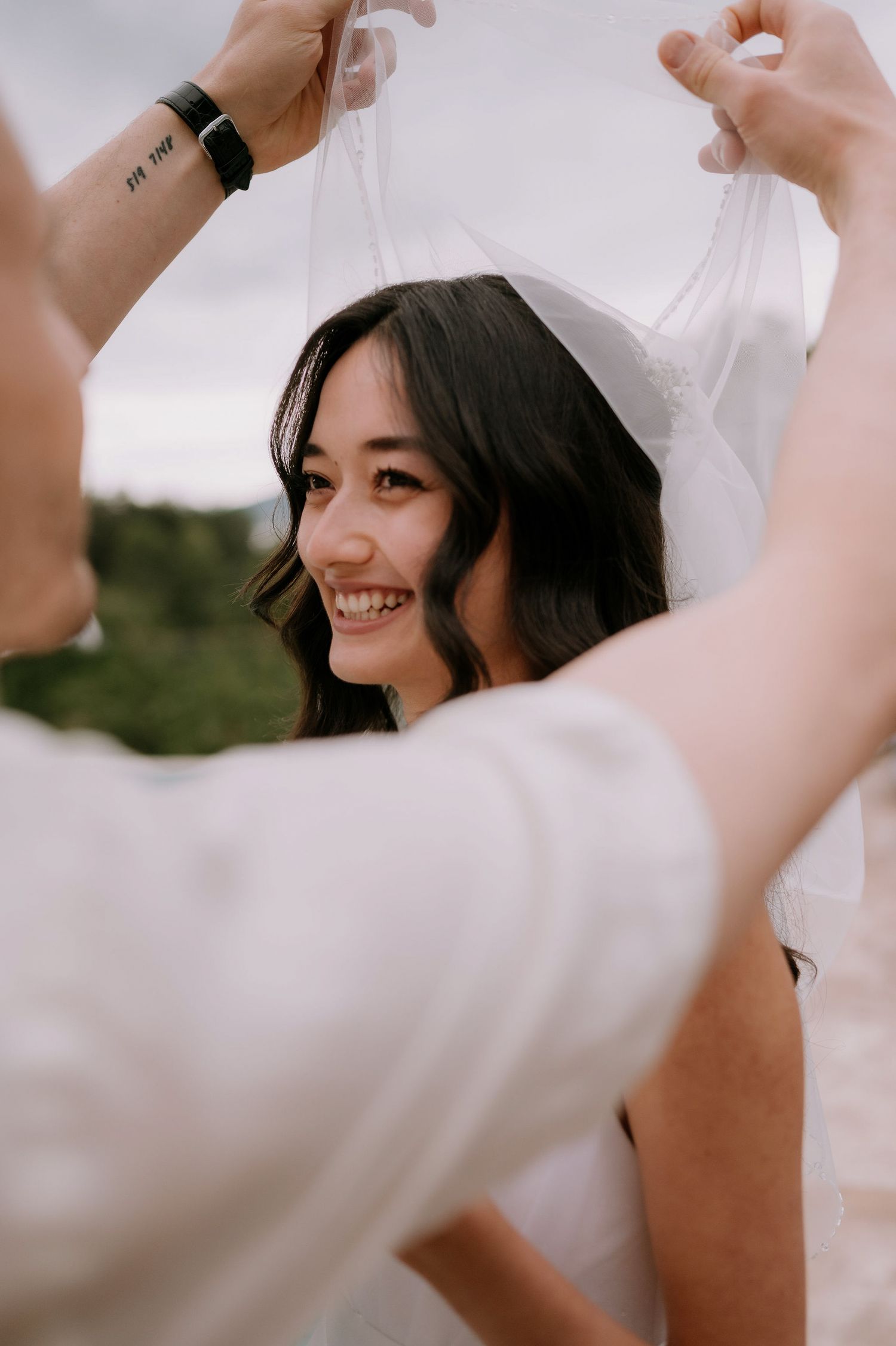 Close-up of wedding ceremony moments with white floral bouquet.
