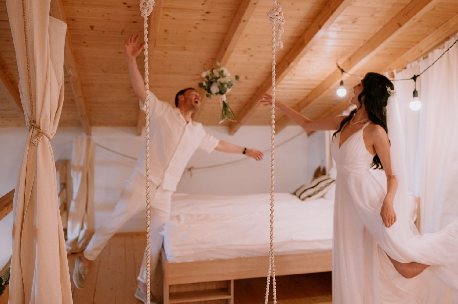 Minimalist wedding photography in rustic attic with exposed wooden beams.