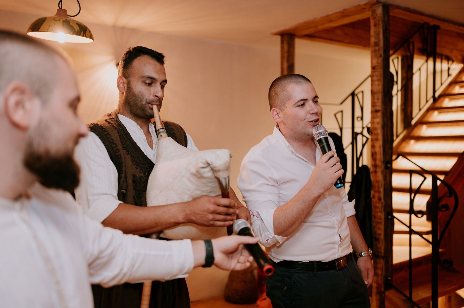 Guests raising glasses in a toast during an elegant indoor celebration.