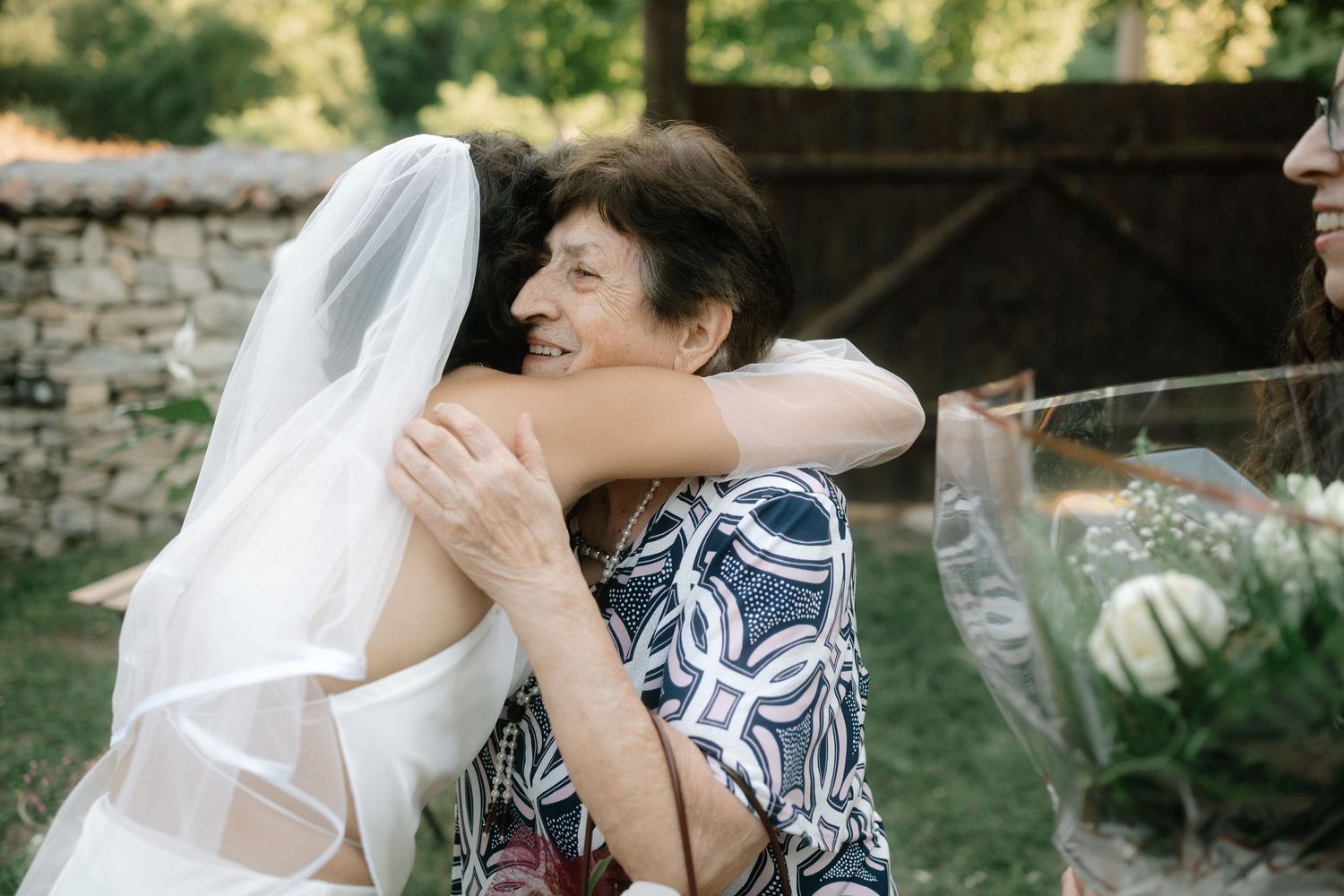 A couple shares intimate moments in a garden setting during their wedding photo session.