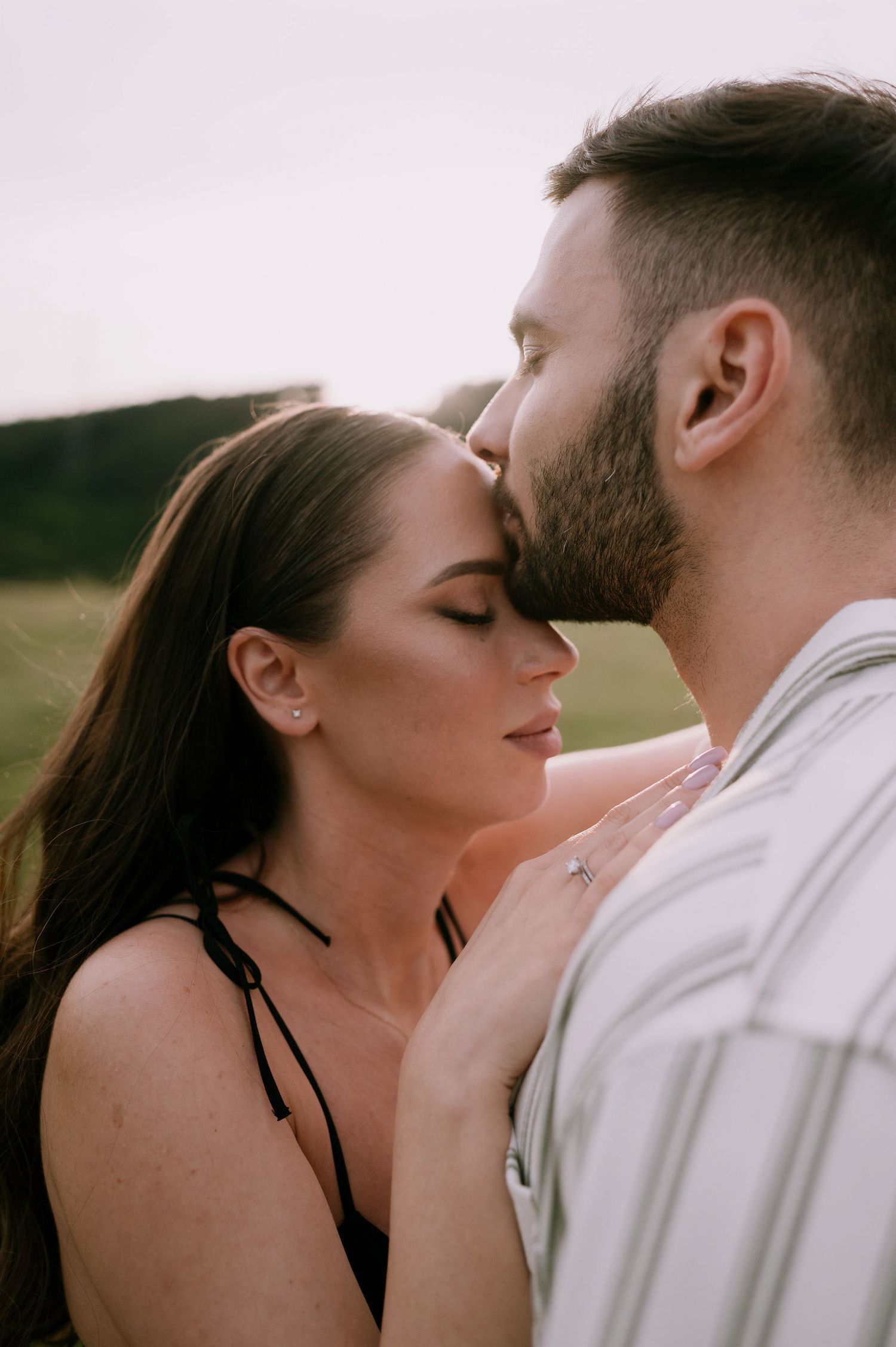 A romantic sequence of intimate close-up shots showing a couple sharing tender kisses in natural outdoor lighting.