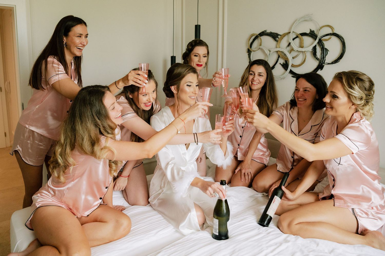 Celebratory group moment in bright indoor setting with matching attire.