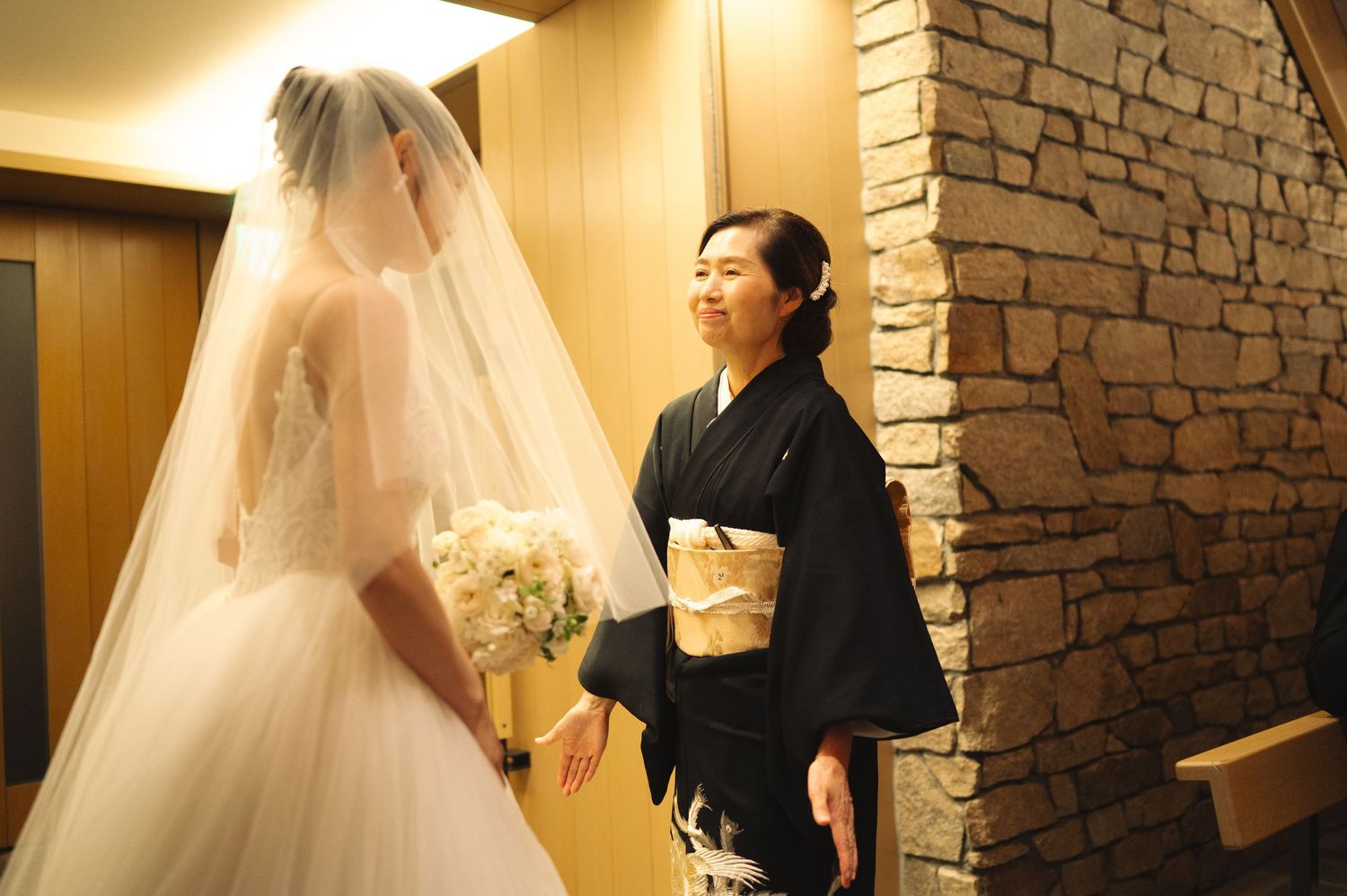 Bridal preparation scene showing meticulous attention to wedding gown details.
