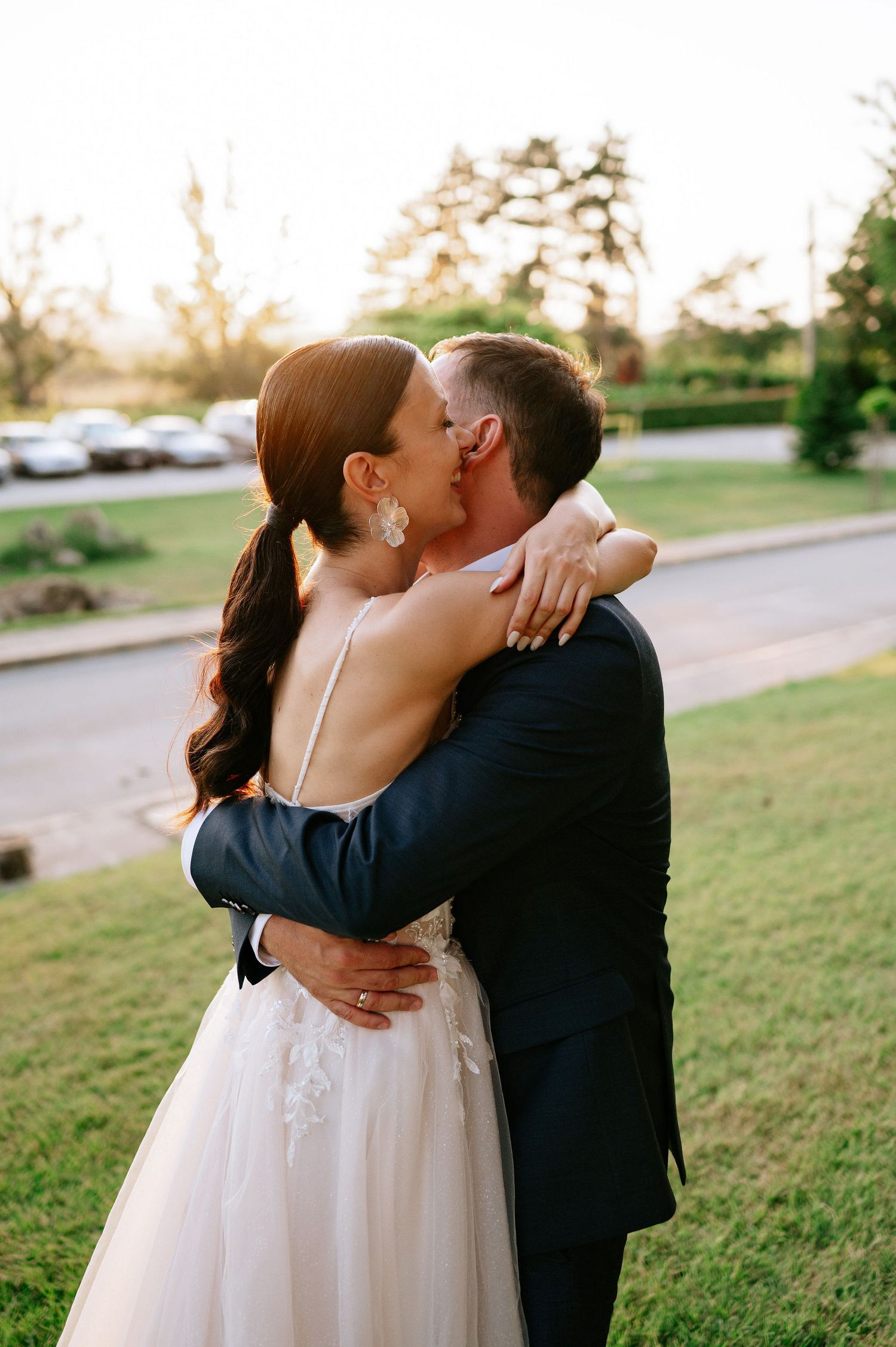 Tender embraces between newlyweds during golden hour wedding photography session.