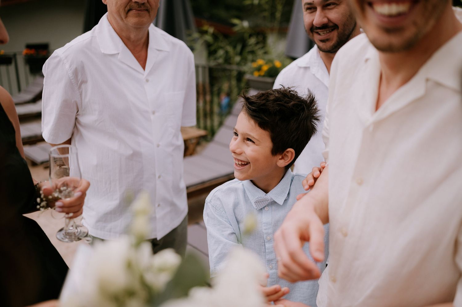 Candid moments of laughter and joy captured during an outdoor wedding celebration.