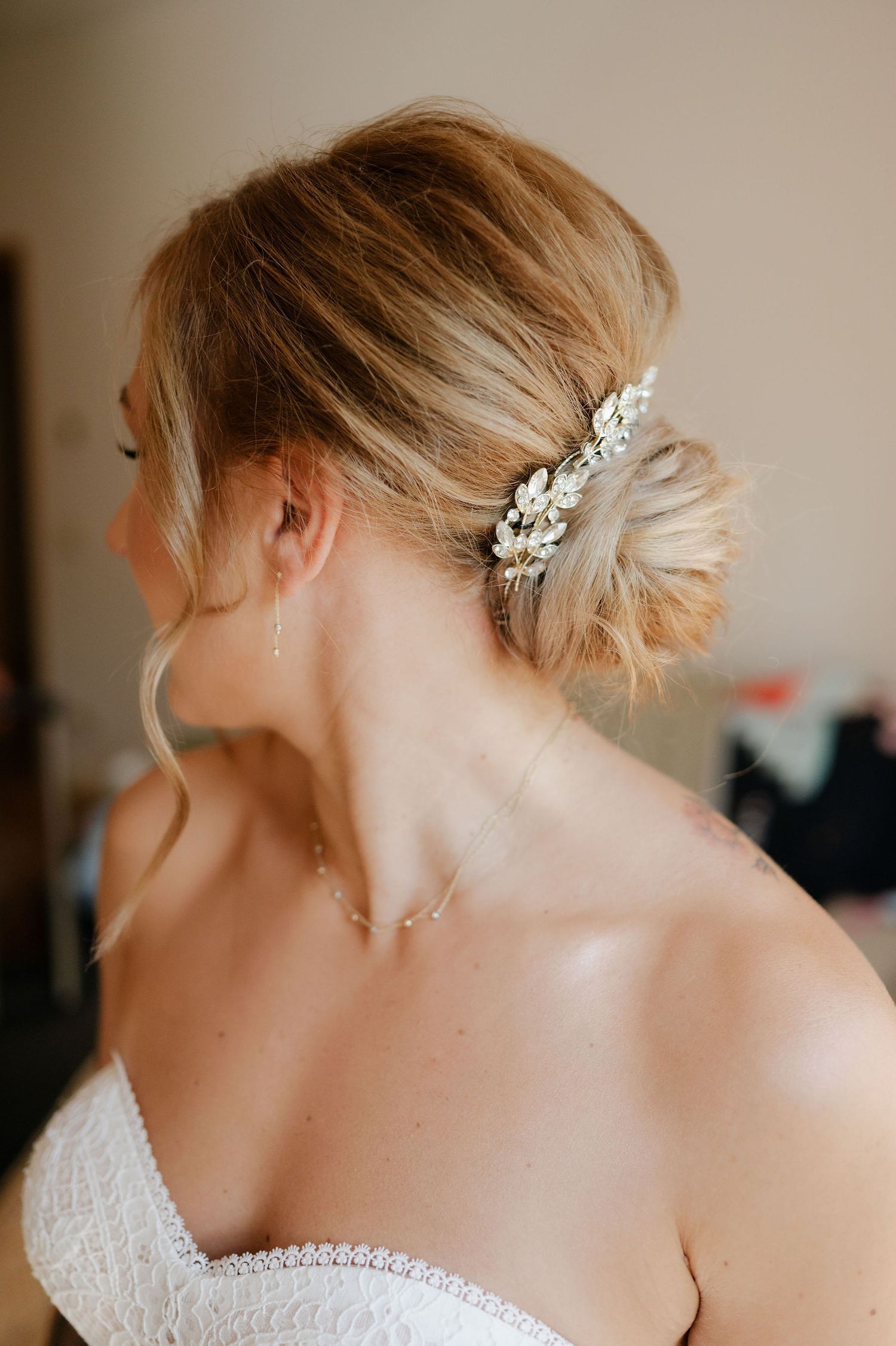 Elegant bridal updo hairstyle with delicate pearl and crystal hair accessories.