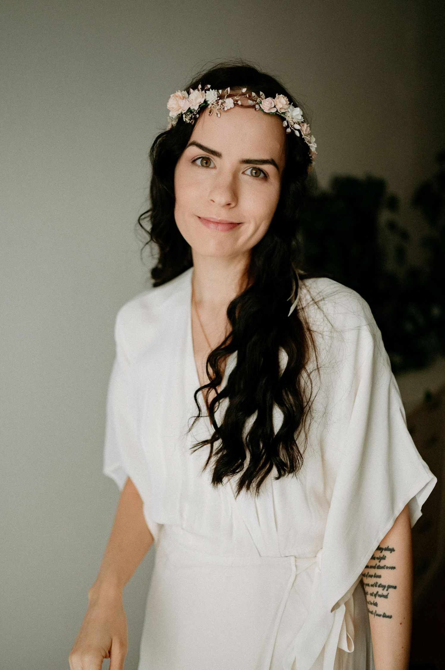 Candid portrait series featuring white clothing and floral headpiece in natural lighting.