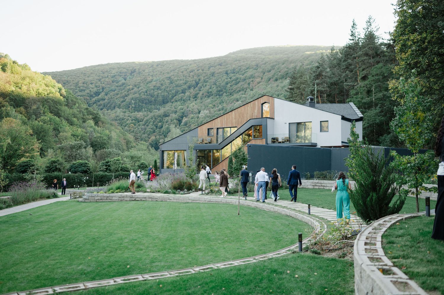 Rolling hills and countryside buildings create a scenic wedding venue landscape.