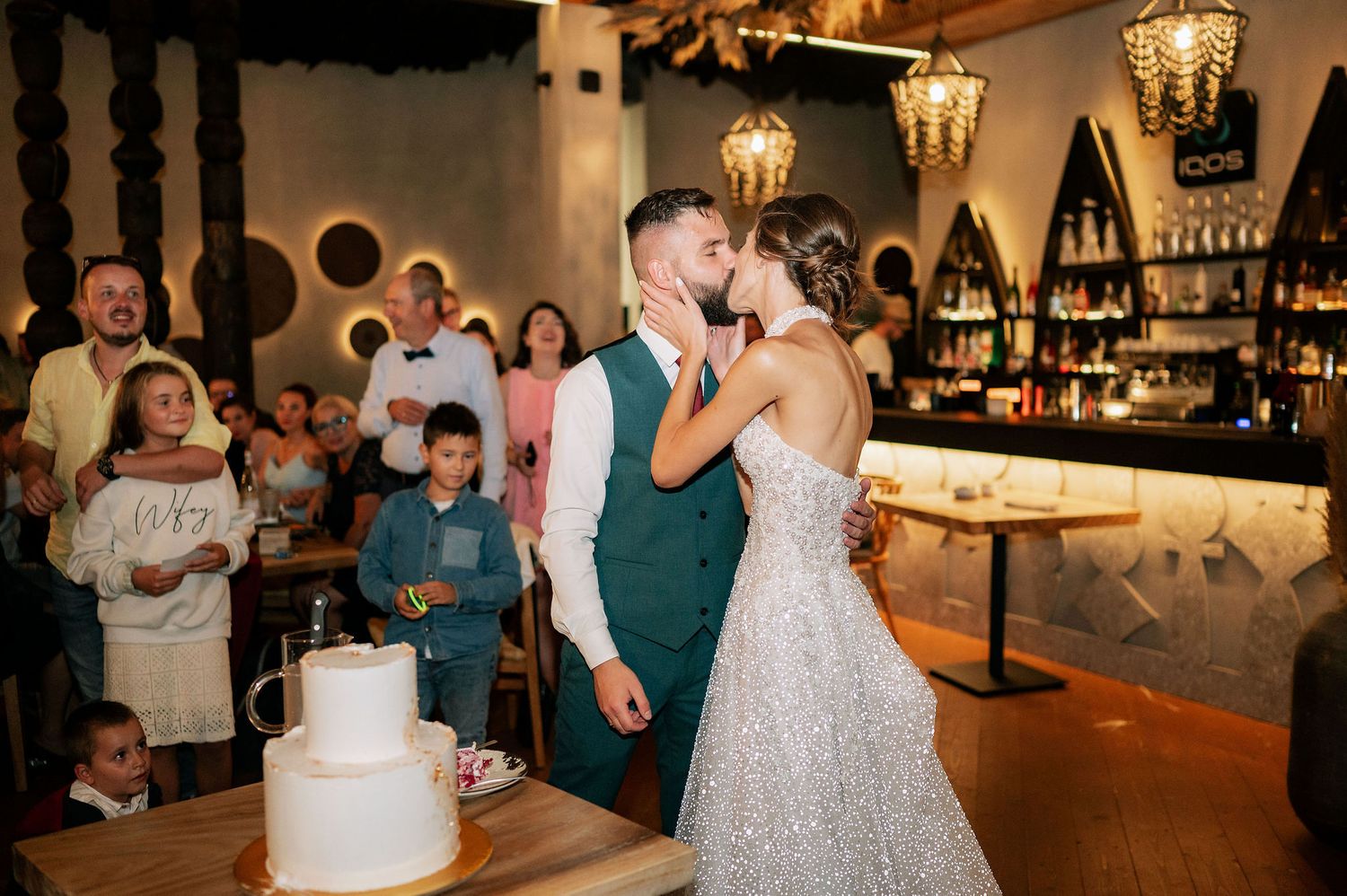 A romantic moment between newlyweds during their cake cutting ceremony.