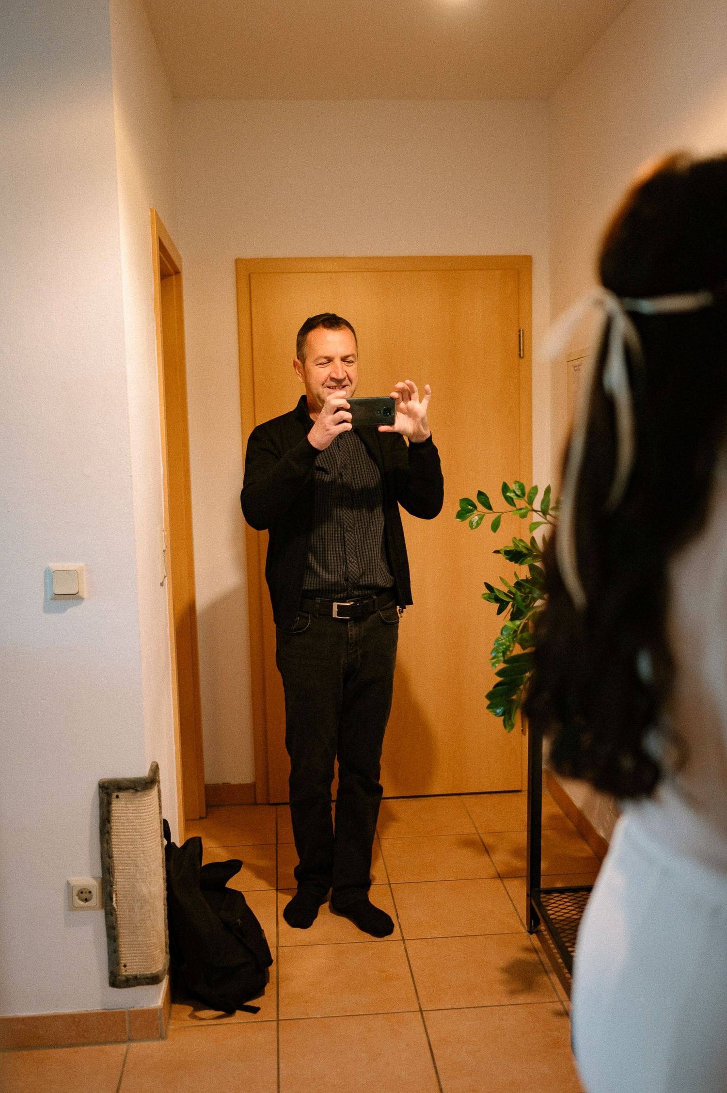 Playful sequence of someone jumping and posing in a hallway.