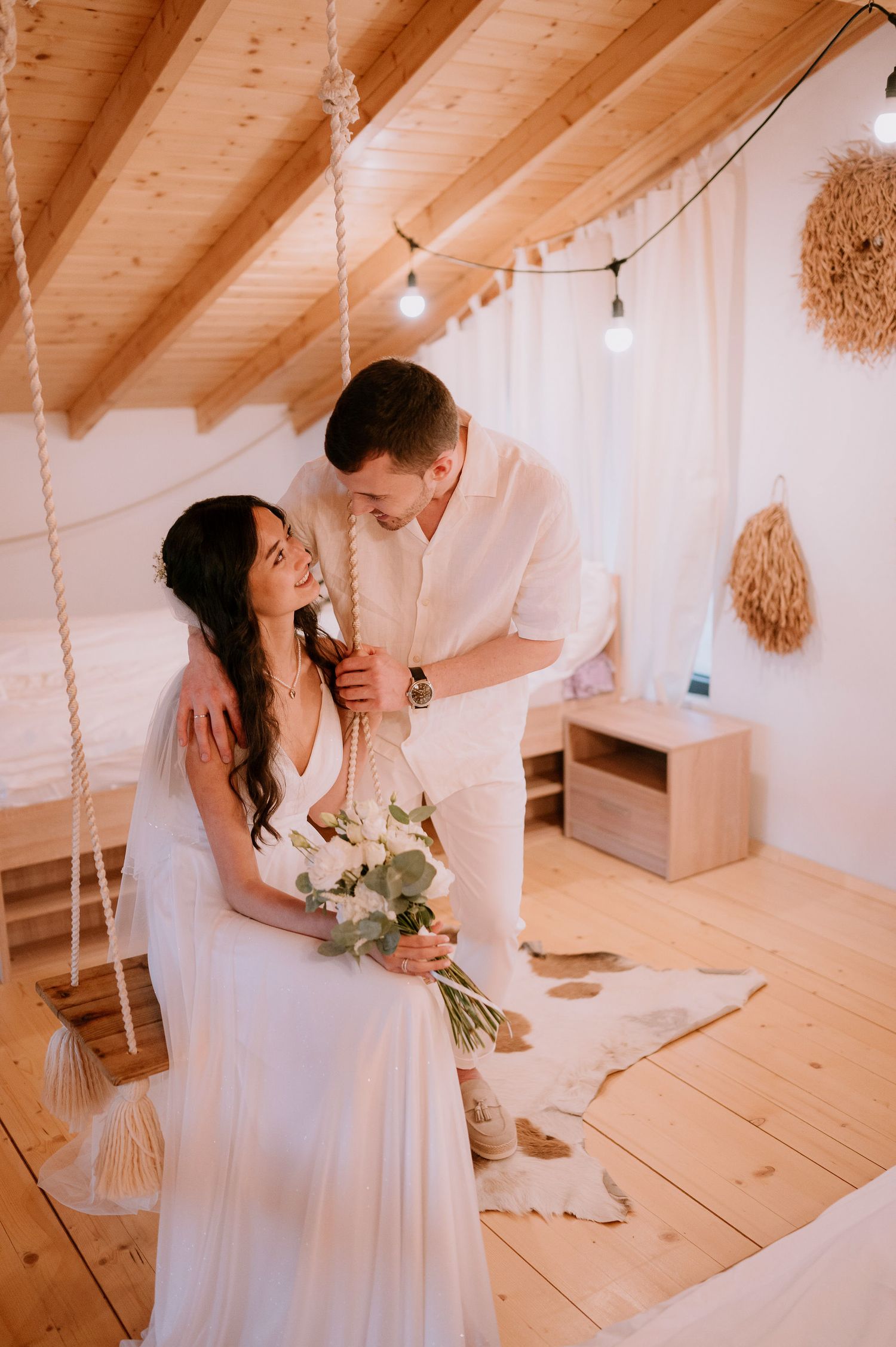 Romantic wedding photography in rustic venue with wooden beams and natural lighting.