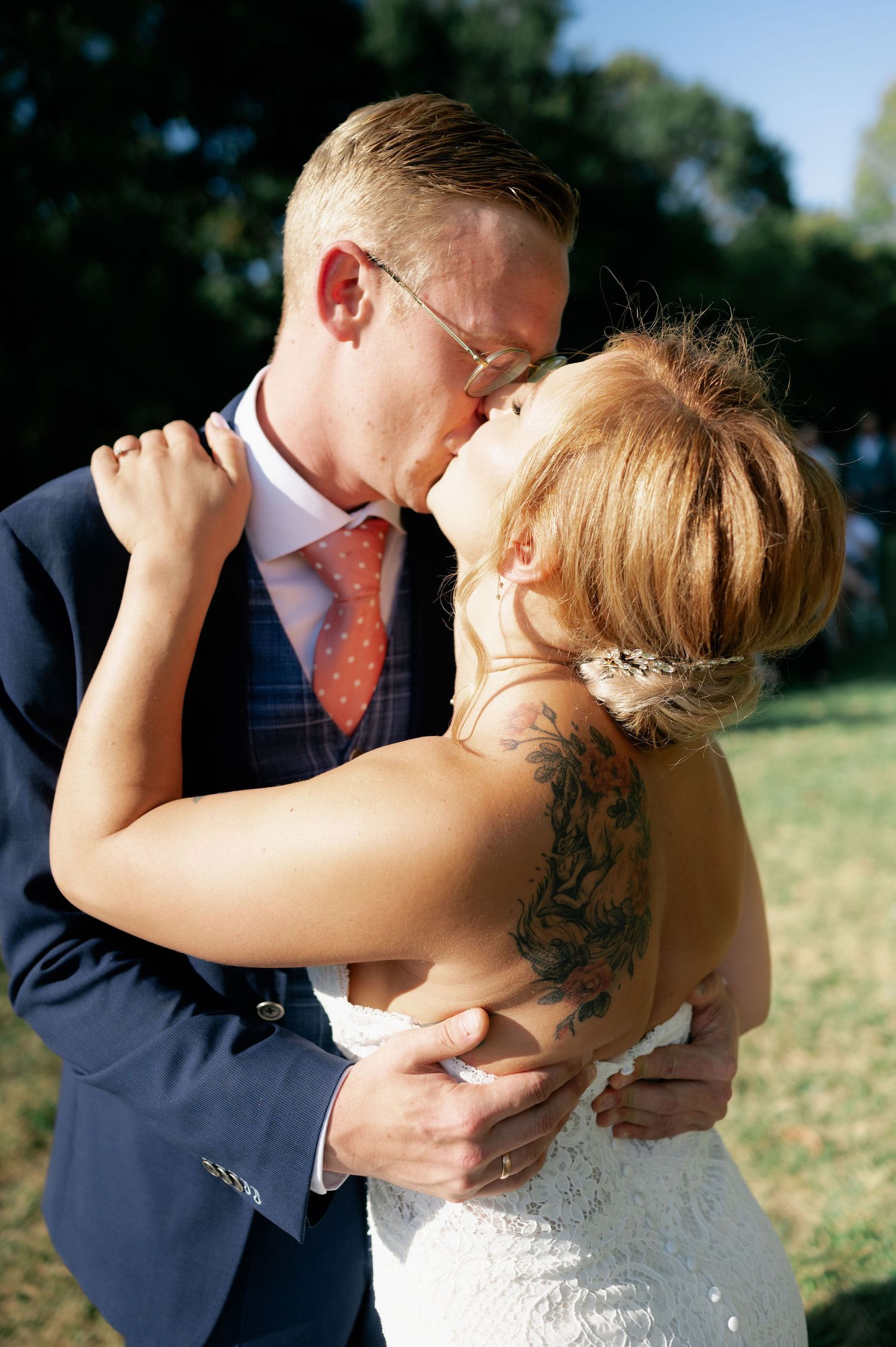 Intimate wedding moments captured in warm sunlight during outdoor celebration.