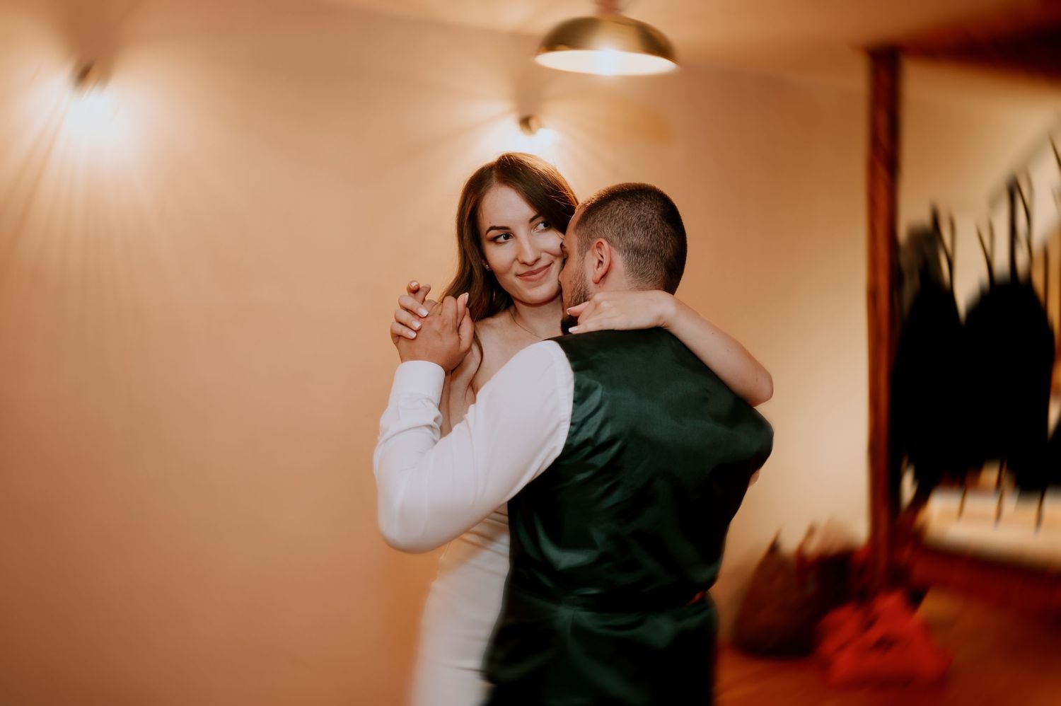 Romantic dance sequence showing a couple performing elegant spins in a rustic venue.