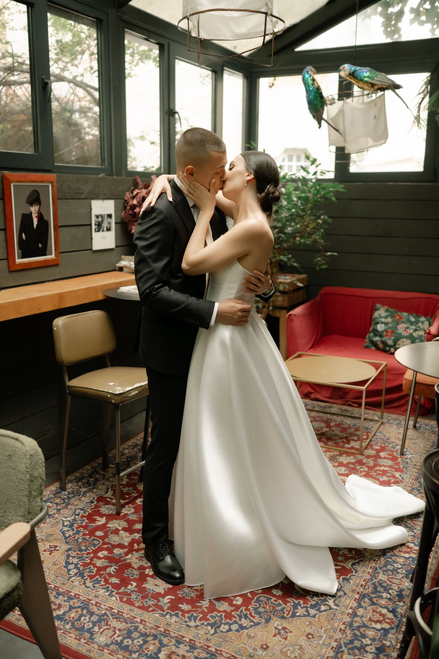 A sequence of romantic dance poses between a couple in wedding attire on a patterned carpet in an indoor setting.