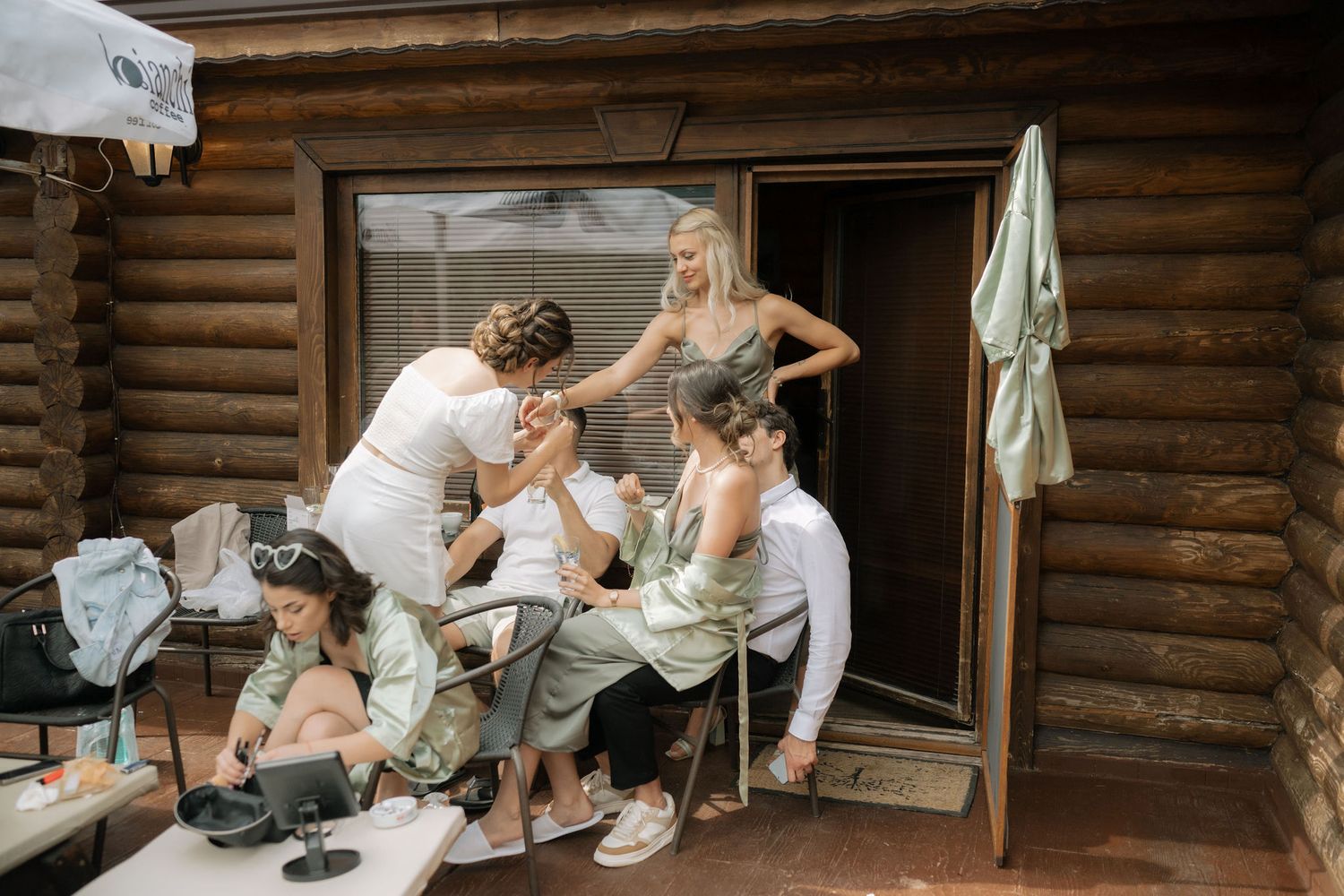 A rustic log cabin wedding scene shows intimate moments of preparation and celebration.