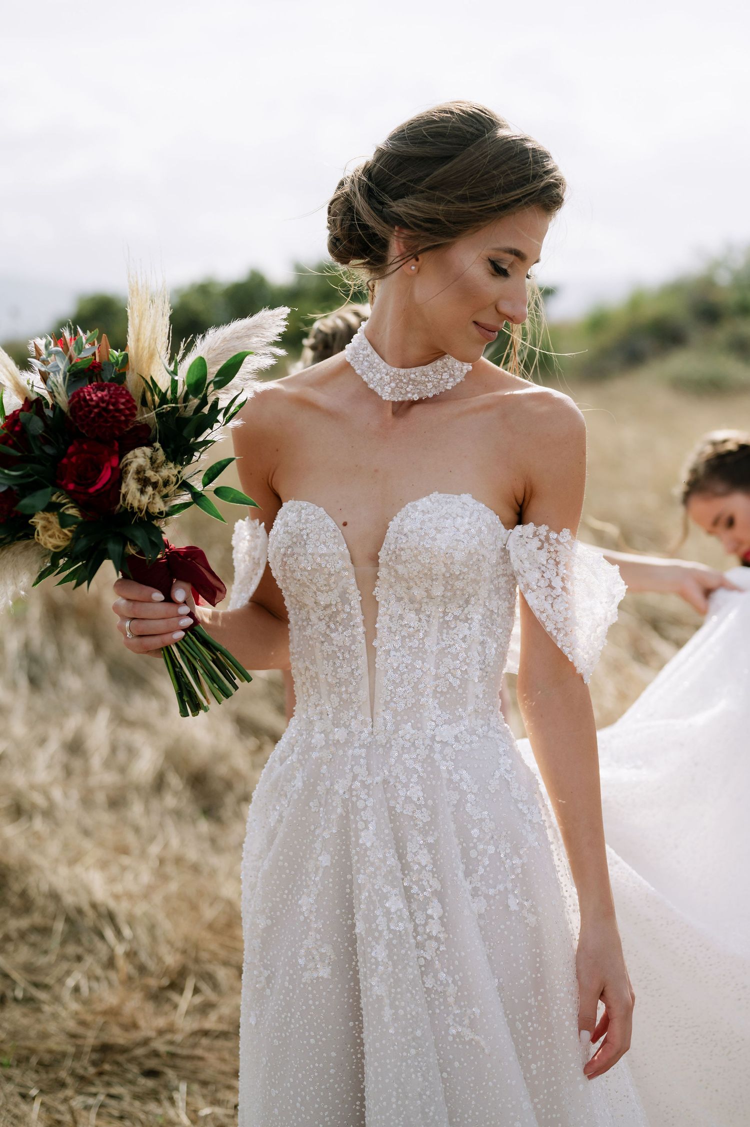 Details of a sparkly off-shoulder wedding dress with delicate lace.