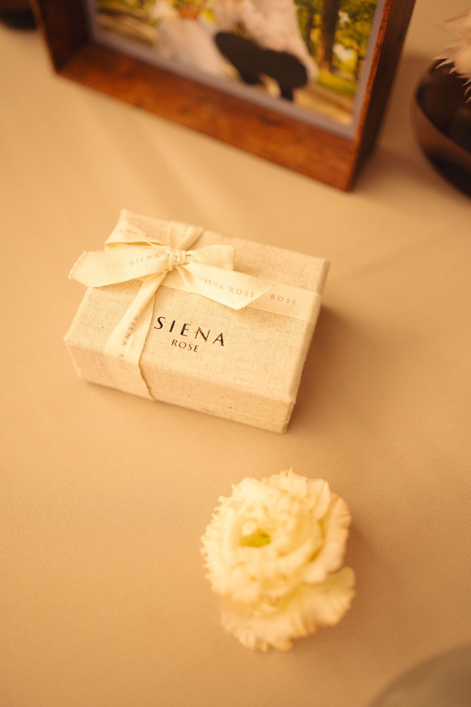 White gift boxes with elegant bows arranged on a neutral surface.
