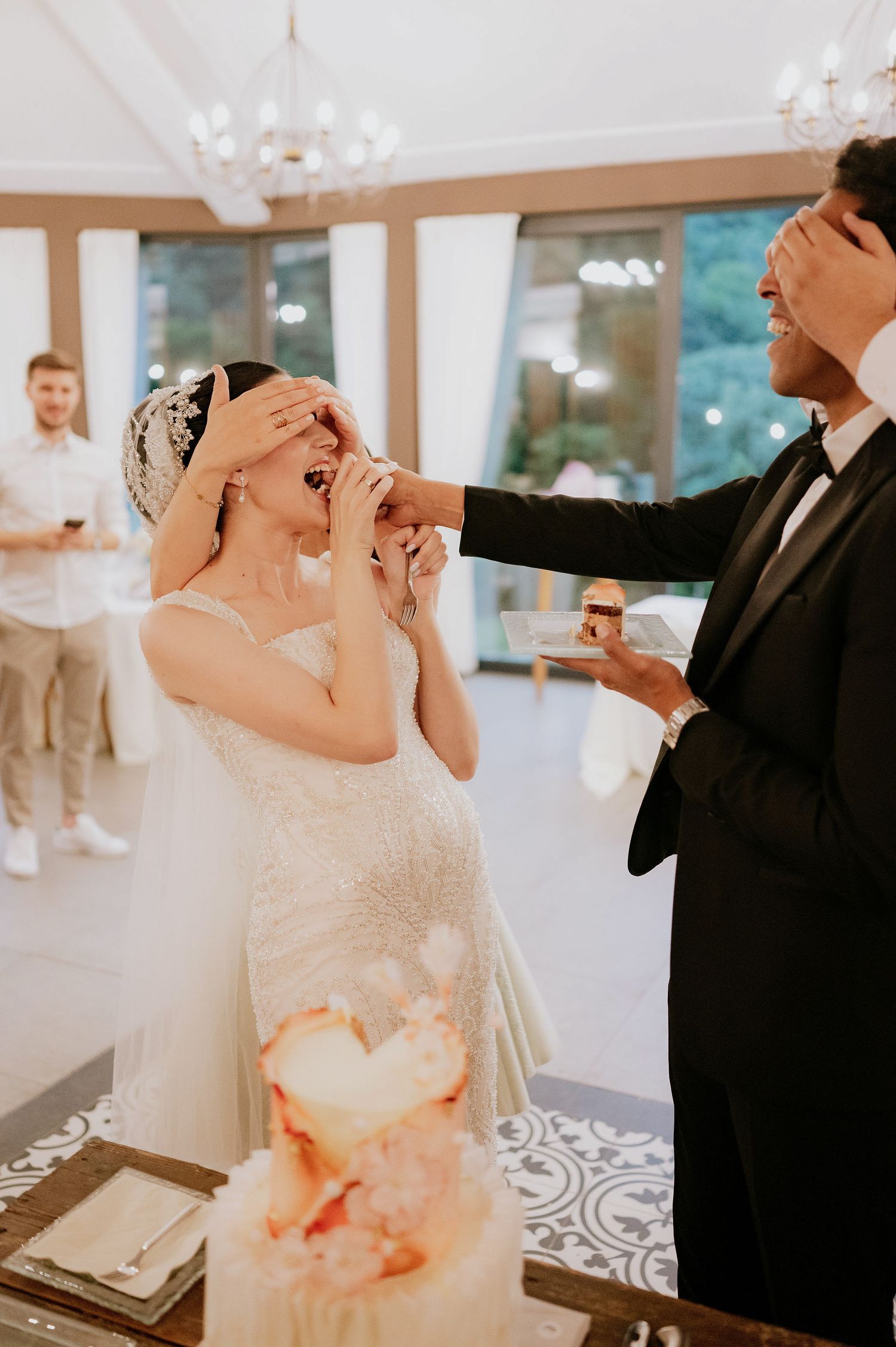 Newlyweds share a playful moment during their cake tasting ceremony.