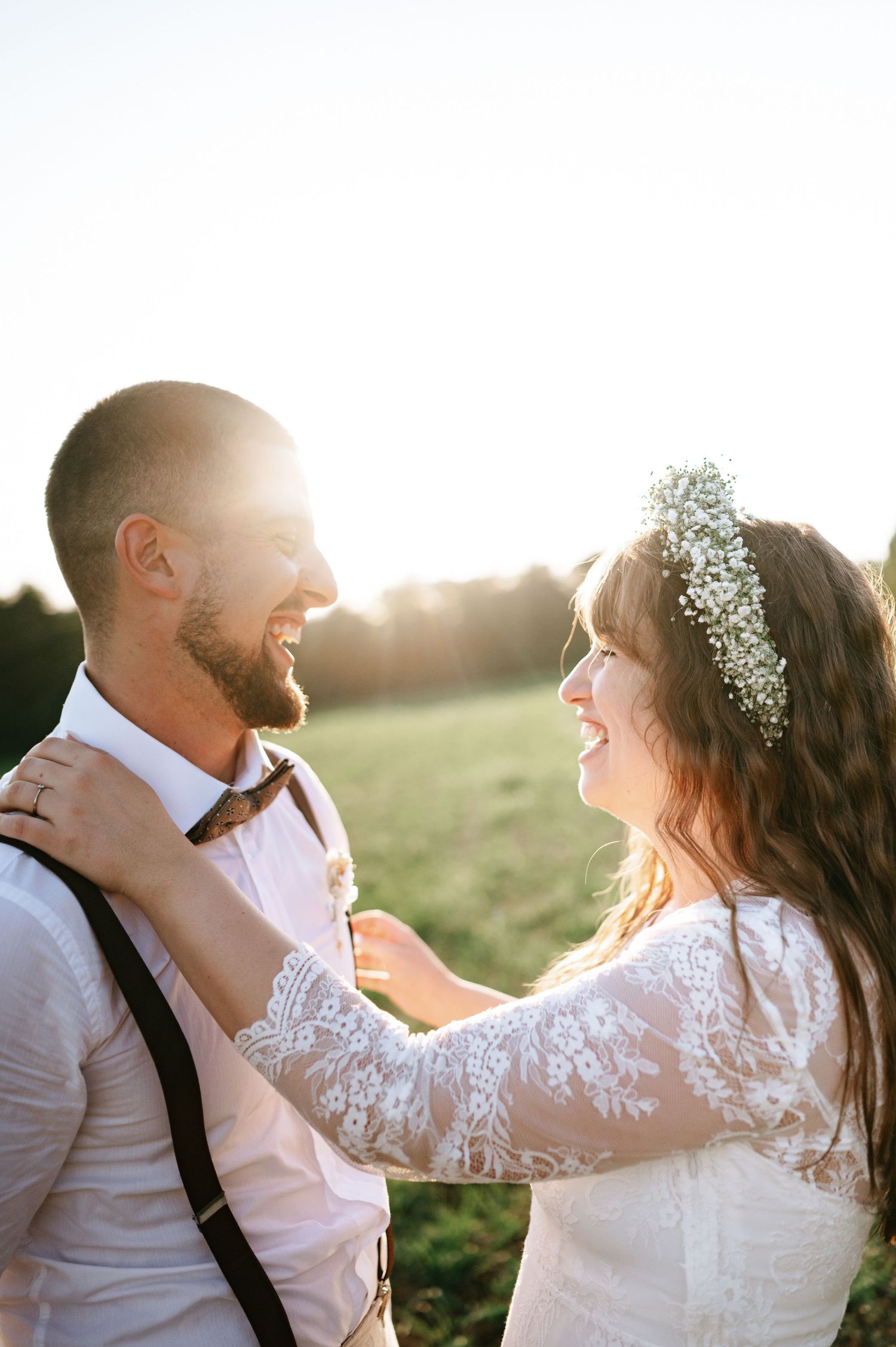 Bride and groom exchange joyful glances during golden hour wedding photography.