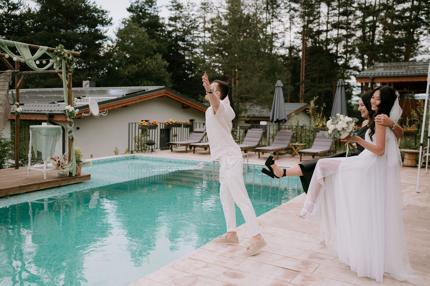 Wedding celebration moments captured by a pool with white and natural decor.