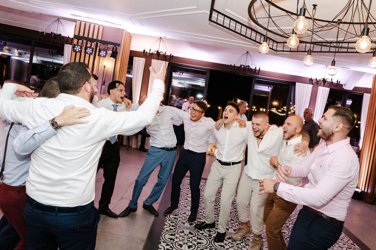 Guests performing synchronized dance moves at a wedding reception in an elegant ballroom.