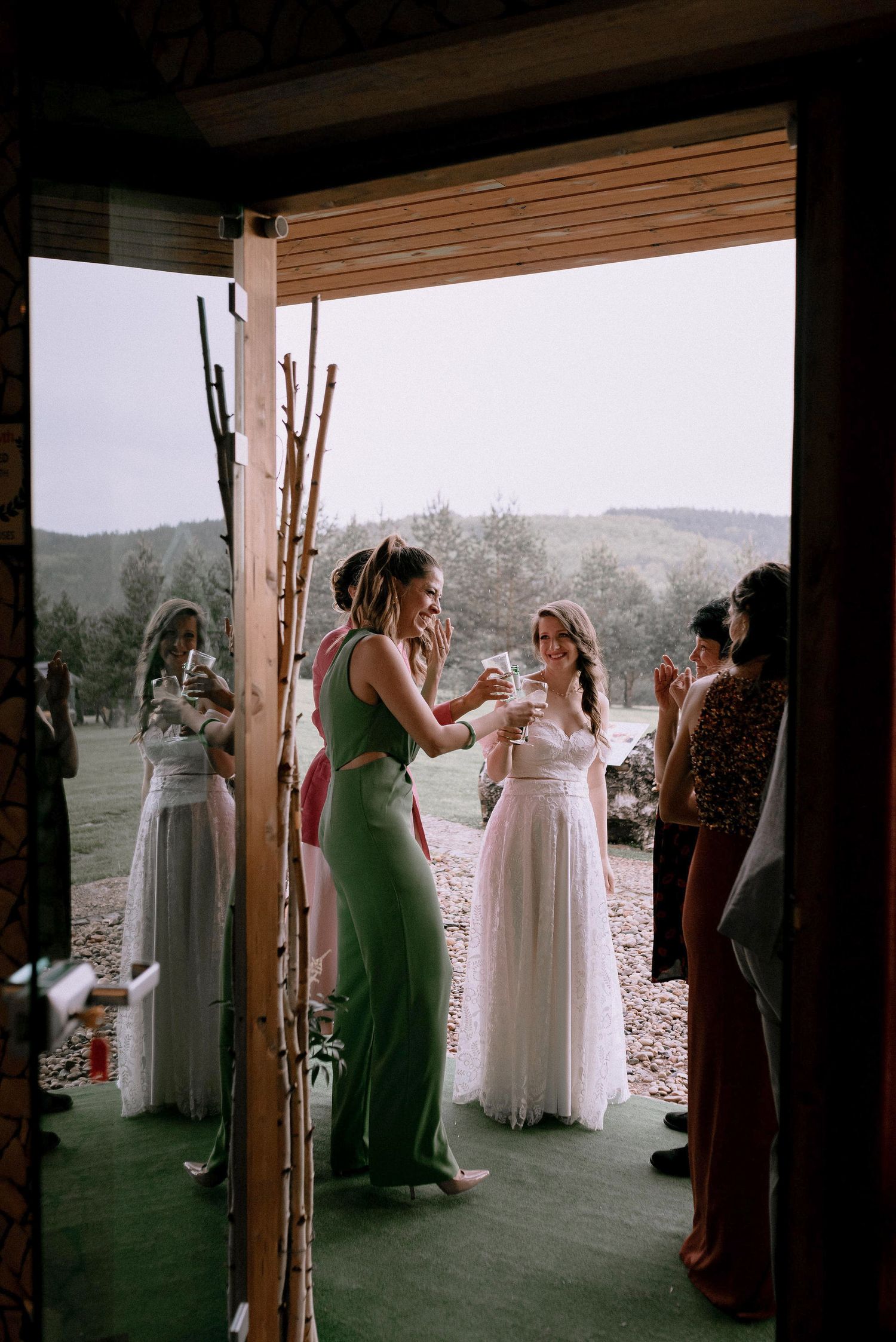 People gathered in an indoor venue with large windows overlooking a mountain landscape.