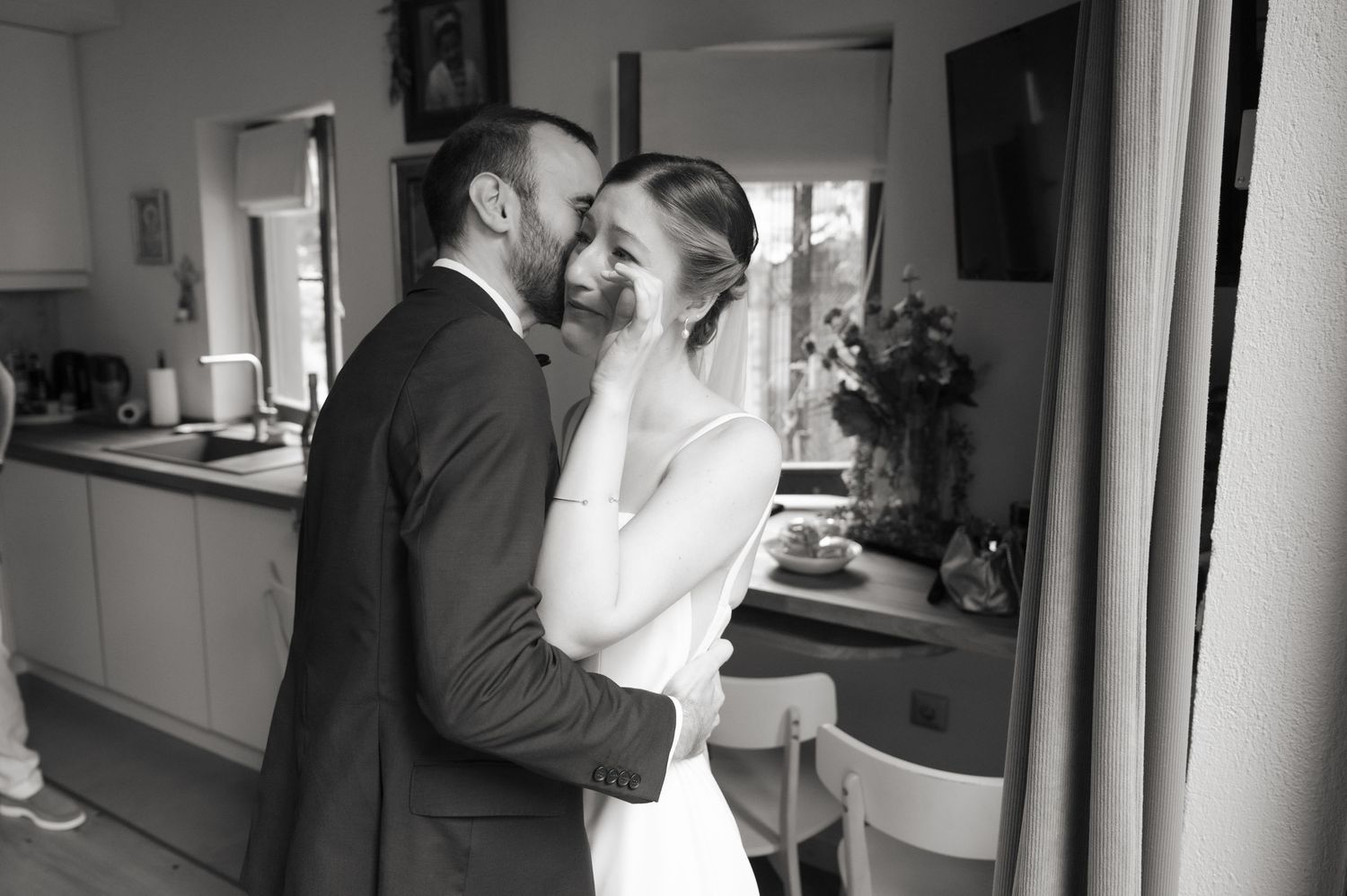 A black and white collage of wedding preparation moments showing grooms getting ready in formal attire.