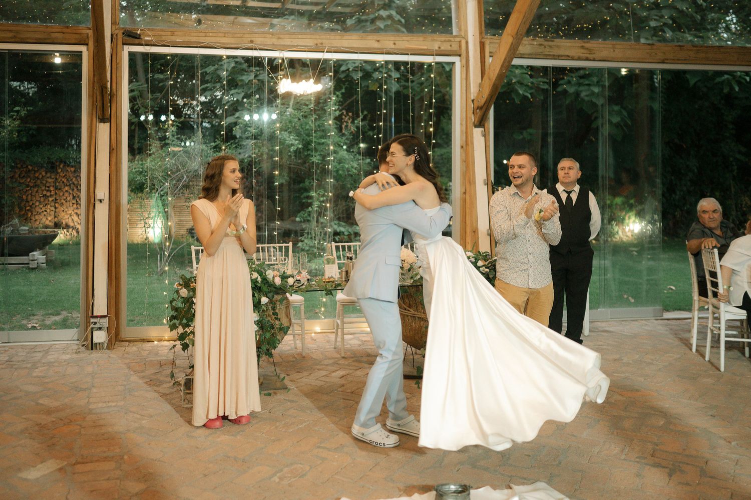 A sequence of wedding dance photos showing couples twirling and celebrating on a covered outdoor dance floor at dusk.