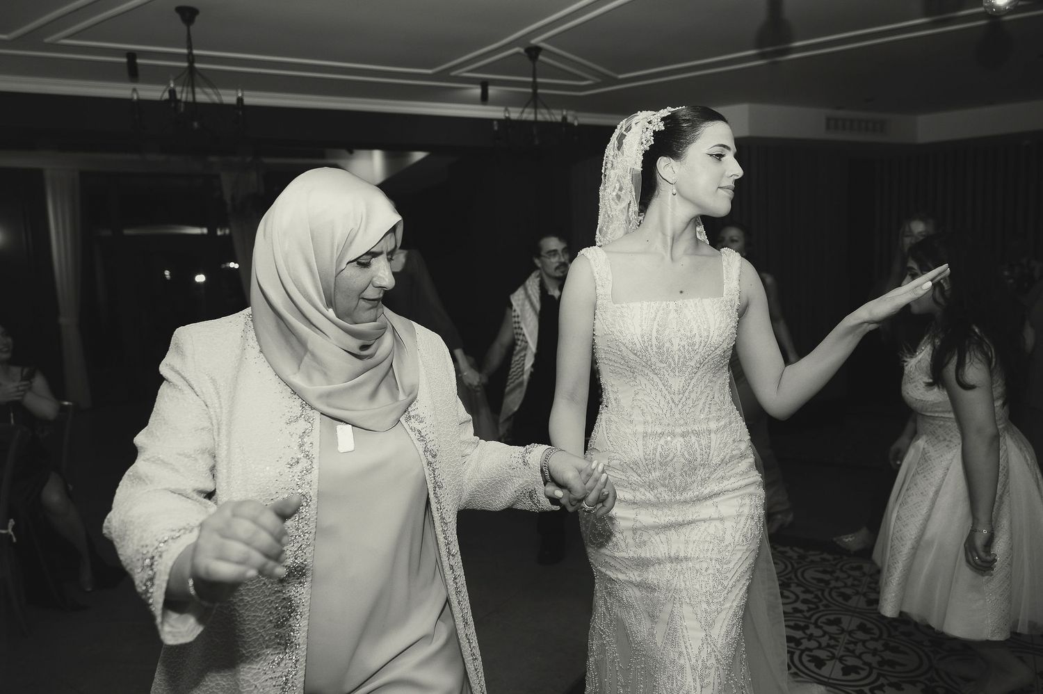 Black and white photos of wedding guests dancing and celebrating on the dance floor.