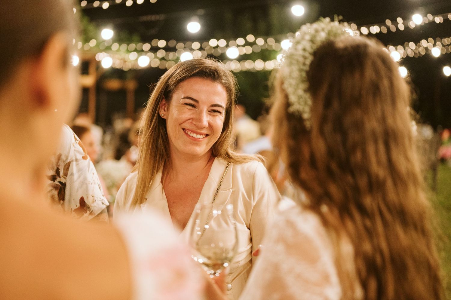 Evening wedding reception with warm lighting and joyful celebration atmosphere.