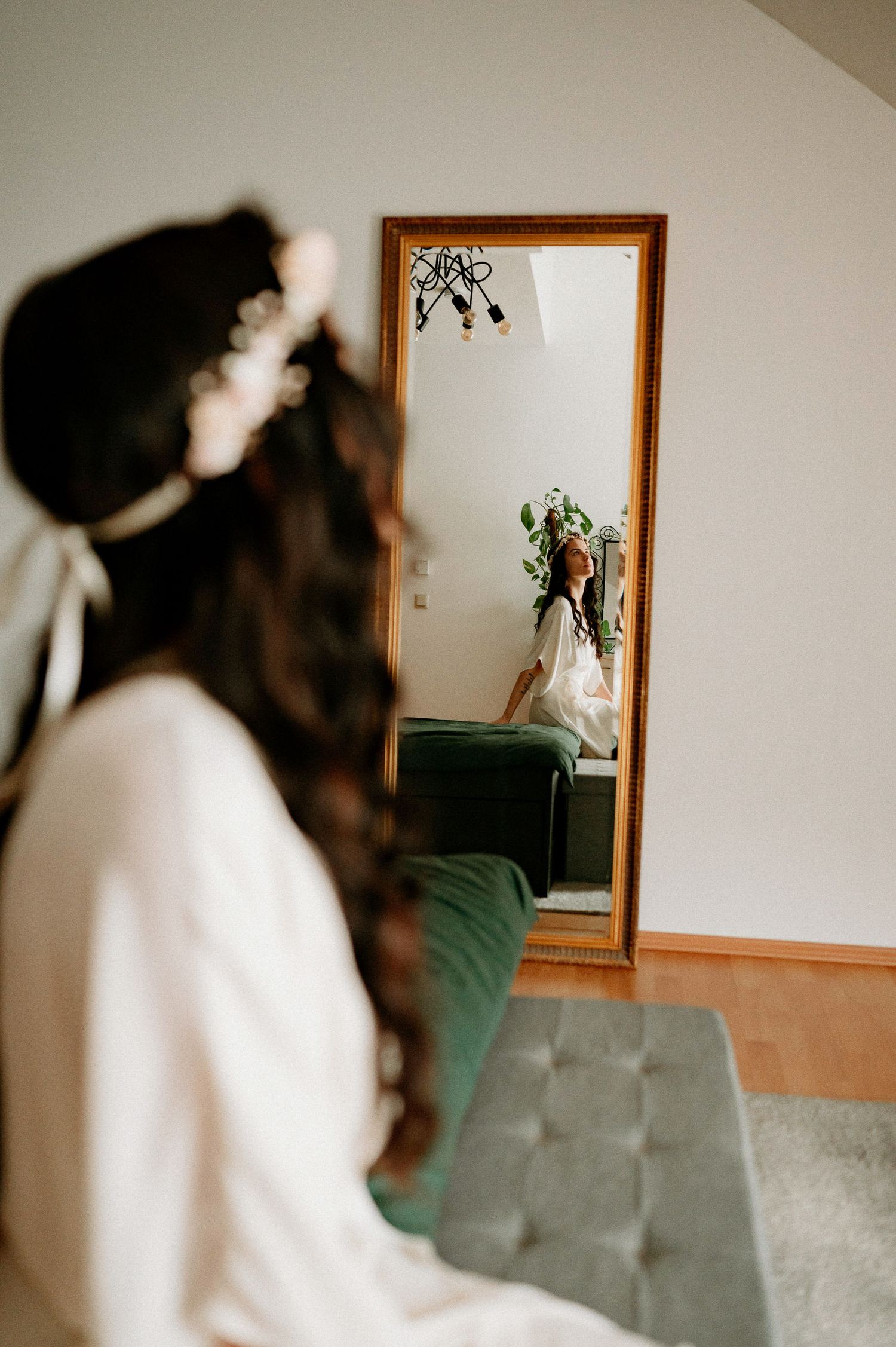 A sequence of blurred motion shots showing someone in white clothing moving near a wall mirror.
