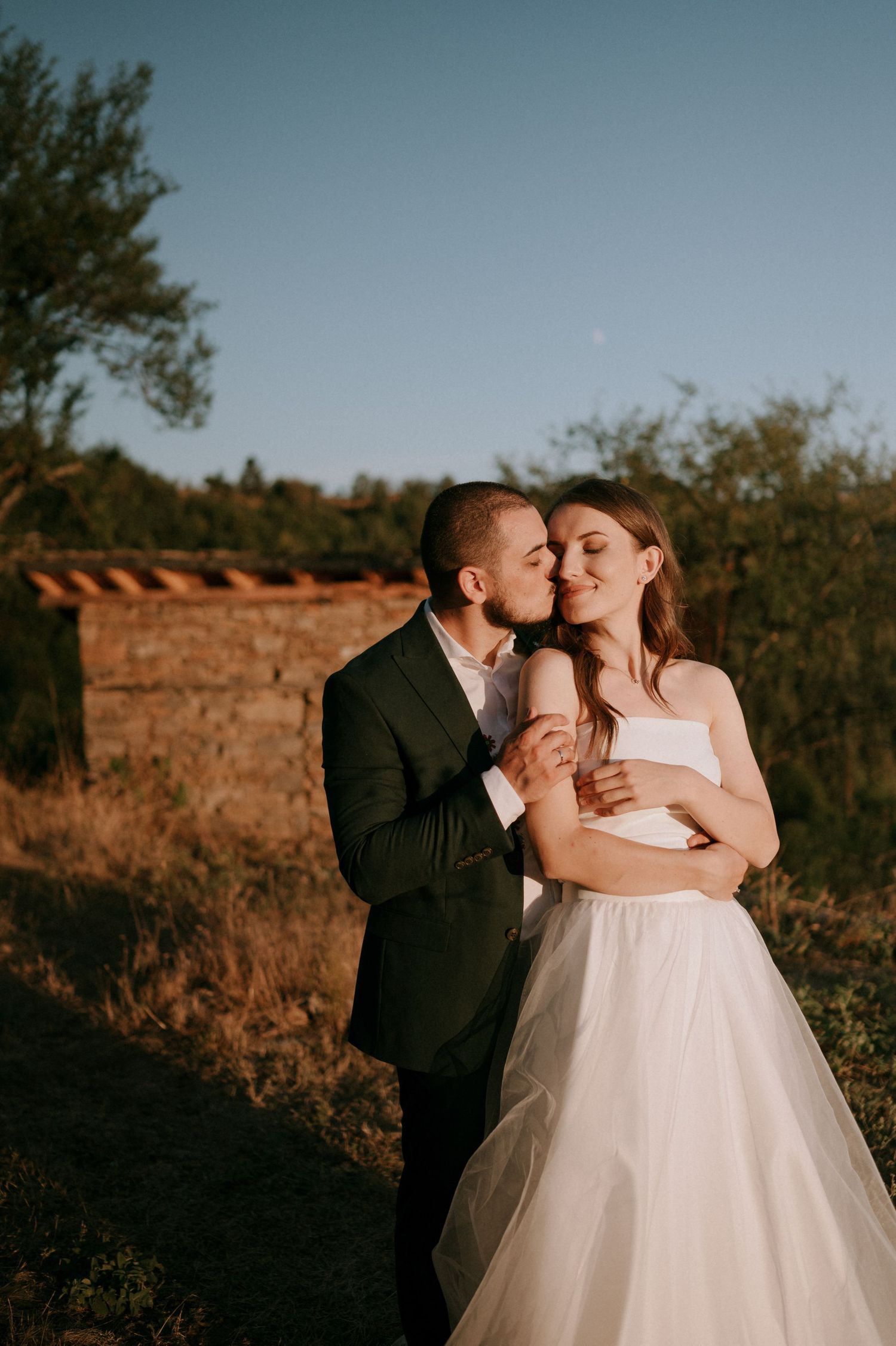 A tender moment between newlyweds during their sunset mountain photoshoot.